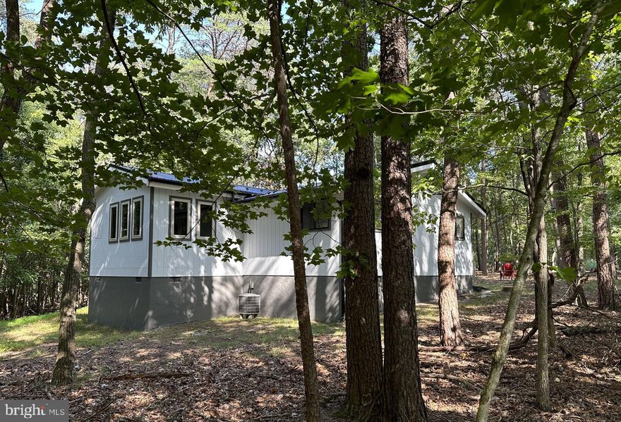 Welcome to AUTUMN LANE and see how the colors have changed! Immaculately maintained, secluded  1.05 wooded corner lot, two bedroom and  a beautiful bath.  Currently under construction!  The Seller has professionally painted the exterior and interior of this adorable lodge home.  They have added a NEW Metal roof,  All new stainless appliances, beautiful granite counters and new light fixtures and fans! The home is equipped with central heat and air, gorgeous hardwood floors (believed to be Brazilian cherry) 
Located on corner wooded lot on cul-de-sac street. Vaulted ceilings through out. 10x24 Screened in porch off of the great room to enjoy your morning coffee or relax in the evening with a glass of wine. Cozy up in front of the wood burning fireplace with slate hearth and wood mantle.
Class B membership available.