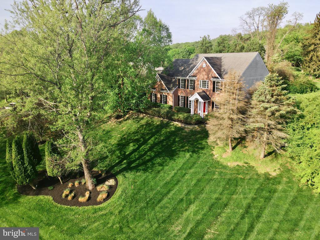 Fantastic Price for the Alert Buyer!!! **Check out the video tour** Welcome to this beautifully Custom built brick front home perched on a scenic hilltop, offering both privacy and charm. Freshly painted throughout and featuring brand new carpet, this move-in-ready residence combines timeless elegance with modern comfort.
Step into the grand two-story foyer with hardwood floors that flows effortlessly into a dramatic two-story family room, highlighted by cascading windows and a striking two-story fireplace that floods the space with natural light. The spacious gourmet kitchen is a chef’s dream—complete with an oversized island, ample 42 inch cabinetry, and seamless access to a relaxing screened porch with TREX decking, perfect for outdoor dining or peaceful morning coffee. The main level also features a desirable FIRST FLOOR BEDROOM AND FULL BATH ideal for guests or multigenerational living in addition to a first floor half bath. Mature trees and professionally landscaped grounds create a tranquil outdoor setting, ideal for enjoying the surrounding nature. Located just a short walk from Pig Tail Recreation Area, where you can fish or boat at the reservoir, and only minutes from Clarksville’s premier shopping and dining destinations, this home offers the best of both convenience and serenity. Don’t miss your chance to own this exceptional home in a truly special setting. Schedule your private tour today!