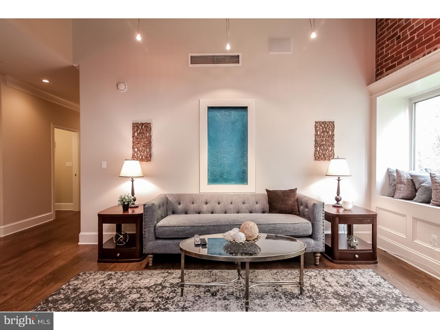 Custom two bedroom residence with high end finishes on Washington Square. Two bedroom plus den, three bath custom built home in The Lippincott with red oak floors, custom lighting, Sonos sound system ready, and eleven foot ceilings with exposed wood beams throughout. Open chef's kitchen with two-tone granite countertops, beautiful wood cabinetry, and a Wolf stovetop with industrial hood and griddle. A large living room features high ceilings, exposed beams, and exposed brick walls. A spacious dining room with gas fireplace leads to a grand terrace with spectacular city views. The den has French doors with decorative hinges, beautiful custom molding, exposed brick, and track lighting. The Master bedroom includes a custom built walk-in closet with pocket doors, one-of-a-kind stained glass window, an ensuite bathroom with Bain Ultra chromatherapy spa tub, his and hers sinks, and a sit-in shower stall. A spacious second bedroom features an ensuite bath. A large utility closet includes a state-of-the-art washer and dryer and additional storage. One parking space and storage space are included with purchase.