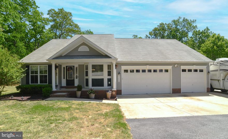 **For the car enthusiast, this home has a four car garage plus a car lift, allowing five cars to be stored at once.**   If you're looking for single level living, look no further! With an open concept, this home sits on a beautiful wooded lot of .64 acres. The backyard is private and fully fenced and has a concrete patio (10'x30')  piped for a jacuzzi,  just off the living room. Inside,  a cathedral ceiling and hardwood flooring  flow throughout much of the main area of the home.  This  home  has a custom built trim package with columns, wainscoting,  and some ceramic tile.  In the kitchen, the cabinets are white and have new granite countertops as well as a new dishwasher and garbage disposal. The garage is a dream with air conditioning and heat  and inside access to a beautifully maintained crawlspace as well as insulated garage doors and one opener.  The single garage space  is deep, measuring at 40'6"X 11'6", with the lift above. All of your toys are sure to fit in this huge space!!  Outside you will find a concrete slab on the side of the house measuring 61'x12', perfect for the RV. The condenser was replaced in the HVAC 1.5 years ago.  This home is just minutes to PAX, shopping, restaurants and Solomon's, and should top your short list! Seller will provide a flooring allowance with acceptable offer.