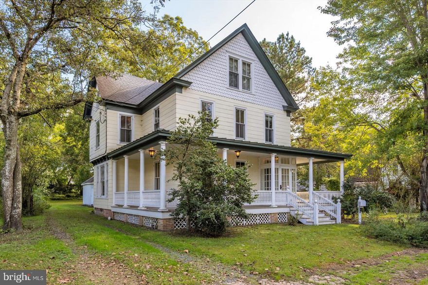 Better professional Photos and Video coming soon!! Amazing Victorian home that has been updated with beautiful details, and sits on a giant private lot in the heart of Snow Hill. Just a short distance from downtown shops, restaurants, nightlife, town events, and in view of parks and the scenic Pocomoke River. All original hardwood floors have been refinished, the home is freshly painted and features a new roof (2025), a new refrigerator, a Tankless Rinai water heater, Dual zone Lennox Heatpumps, Jenn air cooktop with downdraft exhaust system, double wall ovens, and so much more. Beautiful architectural details like the vestibule glass entrance at the front door, curved oak stair railing, and arch-shaped stained glass windows in bay windows on both sides of the house. The home has 3 large Bedrooms with good closet space and a 4th double room with built-in cabinets and a closet. There is also a large walk-up attic giving the home tons of storage space. But what might be considered the best part of this property isn't indoors. Behind the home is a very large yard surrounded by trees that offer great summer shade and definite privacy, which is an oasis away from the world. Fully fenced, this space is perfect for pets, kids, and anything you could want. There is a large two-story outbuilding with garage space, workshop area, and 2nd-floor storage.  The home also has a large wrap around front porch with new raised ridge metal roofing, perfect to sit out on a summer rainy day and listen to the raindrops fall, or greet the trick or treaters when the leaves are changing. Homes like this don't become available often, and you really want to see this one while you can. So call the listing agent or your own agent and get an appointment right away, because if this opportunity passes you by, you will always wonder.......
