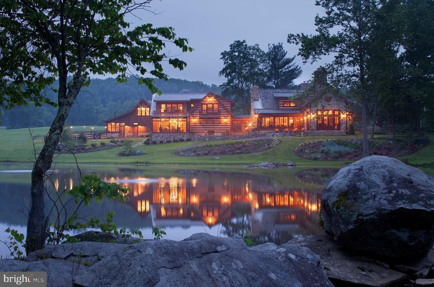 Flat Run Farm was designed and built to satisfy the need for connection with the land and mind.  It offers the opportunity to be a part of something relevant today, and pay homage to the history of the great battles of the Civil War.  This magnificent Adams and Frederick County retreat is divided by the actual Mason-Dixon Line on 217 gently rolling acres at the foothills of the Catoctin Mountains. Equipped with a total of nine buildings, a stocked eight-acre pond, and more than five acres of trails this estate offers picturesque views, tranquility and luxurious functionality.  Sixty-six acres of this private, gated retreat are currently being farmed. Built with local field stone and the finest hand-hewn timbers, this incomparable log retreat is perfectly sited overlooking the pond and surrounded by mature trees, while still flooded with light.  The main home presents a full gourmet kitchen with butler s pantry to meet every entertaining requirement.  The kitchen opens to multiple inviting sitting areas enhanced by six stone fireplaces, walls of windows, and soaring wooden beamed ceilings.   The private owner s suite has elevator service to the main level cleverly tucked in a cylindrical stone silo. There are six additional bedrooms, conservatory, loft and a theater room in the main home.  The sprawling rear stone terrace was designed for grilling, and enjoying a summer lemonade or cocktail after dinner. The workshop/ greenhouse building is sited right off the main home offering a full state-of-the-art wood and machine shop, as well as the potting shed for exterior raised garden beds, a guest bedroom and full bath upstairs, and a powder room on the main level. An absolutely captivating space is to be found in the club house and spa with waterfront views, a full gymnasium, resistance swimming pool, spa, sauna, steam shower and bath.  There is a large second level family room with kitchen, audio visual suite, a gas fireplace, billiards, shuffleboard and second level deck overlooking the pond. There is a two-car garage for the main house, space for two to three cars in the workshop, and a four-car auto barn ready for a car collection and all terrain vehicles. The pavilion was just added for pure outdoor fun.  It is equipped with two outdoor barbecues, and a large stone fireplace.  A perfect place to gather to tell stories, relax and entertain.  The pavilion features full audio visual and will comfortably hold up to 50 guests. Three original barns were kept and painted traditional barn red, with one converted into a half court basketball court while the others are used for holding farm machinery. Flat Run Farm also offers additional space for caretakers or guests to reside. Make an appointment to experience this dream retreat in person.