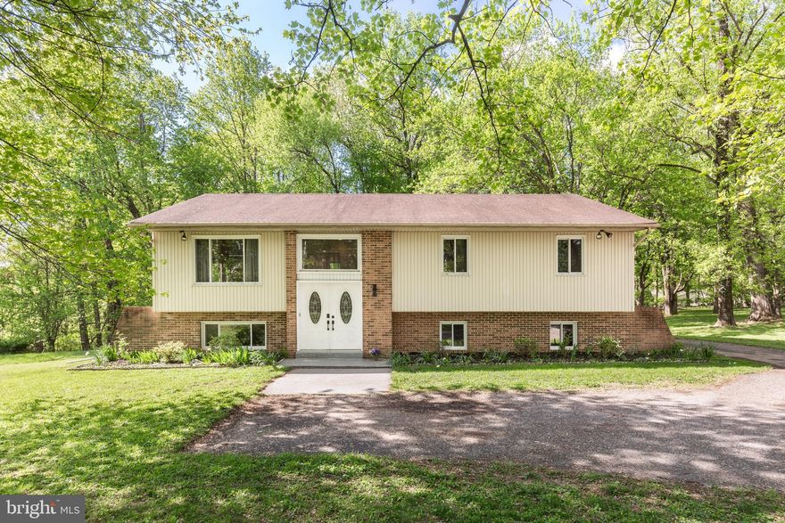 Welcome to 12360 Greenspring Avenue! This home offers easy commutes to Hunt Valley, Baltimore and Owings Mills+ yet offers a peaceful retreat when you return home. Situated on an expansive .79 acre lot that extends well into the trees, you'll be treated to sightings of deer, fox and even the occasional wild turkey while entertaining or relaxing on the new deck (or the patio below).  On the main level, you'll find 3 bedrooms with hardwood floors, including a spacious primary bedroom with ensuite bath, an updated hall bath, living & dining areas (also with hardwood flooring) and a spacious kitchen with access to the deck. The fully finished basement offers a large  space that can be tailored to your needs - a family or rec room, home office, gym or playroom. Sliding doors from this space provide easy access to the patio and backyard. An additional full bath and bedroom (with walk-in closet), as well as the laundry/mechanical room (with its own access to the backyard), round out the lower level of this spacious home. New HVAC (2022), new Bradford White hot water heater (2022), deck (2024), well pump (2024), shed (2020)