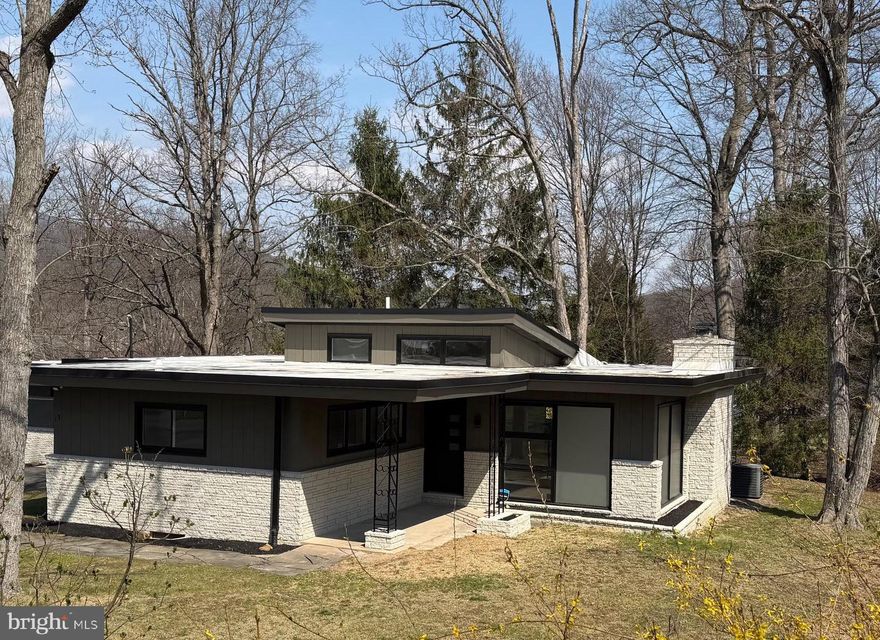 Step right into your very own slice of cool—this mid-century modern beauty is anything but ordinary. Originally a Redwood home-kit all the way from California (yes, really!), this one-of-a-kind gem brings serious character you won’t find anywhere else nearby.  Inside, the vaulted kitchen ceilings set the tone for an open, airy vibe, perfectly paired with a sleek, modern kitchen.  The living room fireplace adds just the right amount of cozy to balance all that style.  Freshly painted from top to bottom (inside and out), this home is shining bright with new luxury plank flooring in the main living spaces, custom tile work in the primary bath, and those charming original square-pattern hardwood floors holding it down in the bedrooms—because some classics are just too good to change.  Downstairs, the finished den plus oversized laundry and workshop area opens the door to endless possibilities—home gym, game room, bar hangout, hobby haven…you name it.  Out back, nature’s got your back—enjoy a private setting from your covered porch.  You’re tucked away on a quiet dead-end street right in the heart of Lavale, with parks just a short stroll away.  Mid-century charm, modern updates, and a layout that keeps things interesting—this home isn’t just a place to live, it’s a conversation starter.
