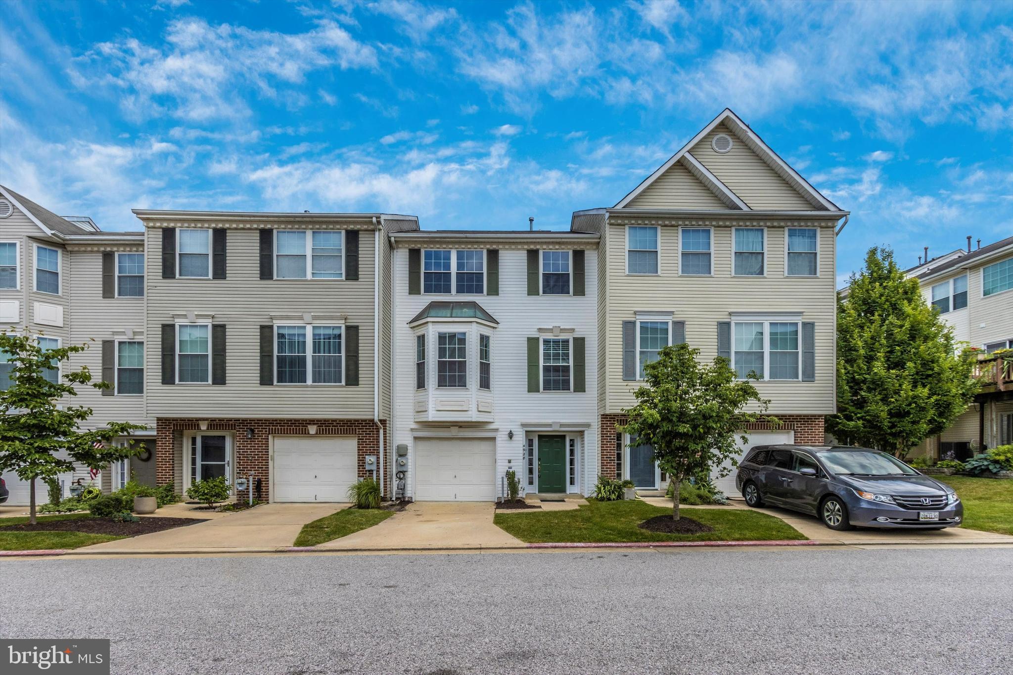 RENOVATED and Ripple gray paint townhouse in ELLICOTT City 3 Bedroom 2 full bathrooms and 2 Half bathrooms with attached garage - Kitchen level Deck overlooking backyard.