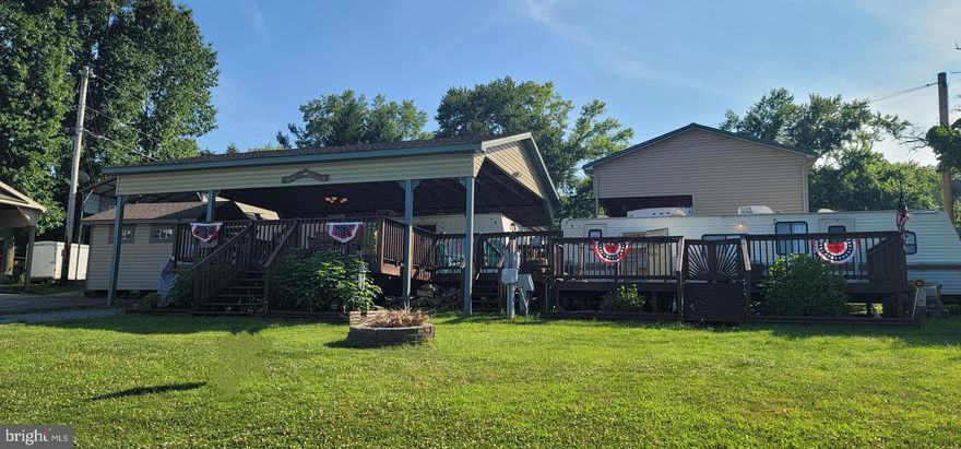 TWO lots in River Bend Park! Two lots with two campers (1997 and 2004), long deck and cover over campers and deck! Deck is nearly the length of both campers and has plenty of room for entertaining or just relaxing. Each entrance is gated to keep your pups safe and enclosed. The 2004 camper has a private bedroom, a private bunk room, a full bathroom with tub and lots of living space or the table and couch can be pulled out to be used as additional sleeping areas. The 1997 camper has been recently updated and made into a perfect bunk-house for your kids, grandkids, visiting friends and family, etc. It includes a large living space with storage cabinets and cubbies (no kitchen), a private bath w/stand up shower and 2 TWO private bedroom areas. River Bend is a 400 acre seasonal community open from April 1 to November 1. Located along 10 miles of deep water on the Potomac River allowing for recreational activities like boating, fishing, swimming, kayaking, canoeing along with many community activities like swimming pools, boat club, trick or treating, basketball court, tennis court, fireworks, car show, playground, bar and restaurant and so many more.