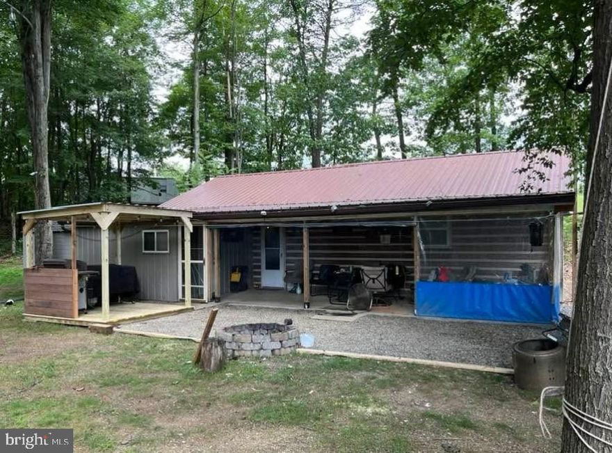 CABIN ON 11.57 ACRES in a private setting on Piney Ridge. This upgraded cabin offers the perfect escape between Huntingdon and Seven Points Marina at Raystown Lake. Ideal for entertaining, the property features inviting indoor and outdoor spaces, perfect for gatherings, campfires, and relaxing in nature. Enjoy endless opportunities for hiking and ATV riding right on your own land. The property is enrolled in Clean & Green for low taxes and is not part of a development—no HOA fees. Additional highlights include a covered area for boat parking and convenient RV hookups, making it easy to host guests or enjoy weekend getaways. A rare opportunity for privacy, recreation, and comfort all in one.