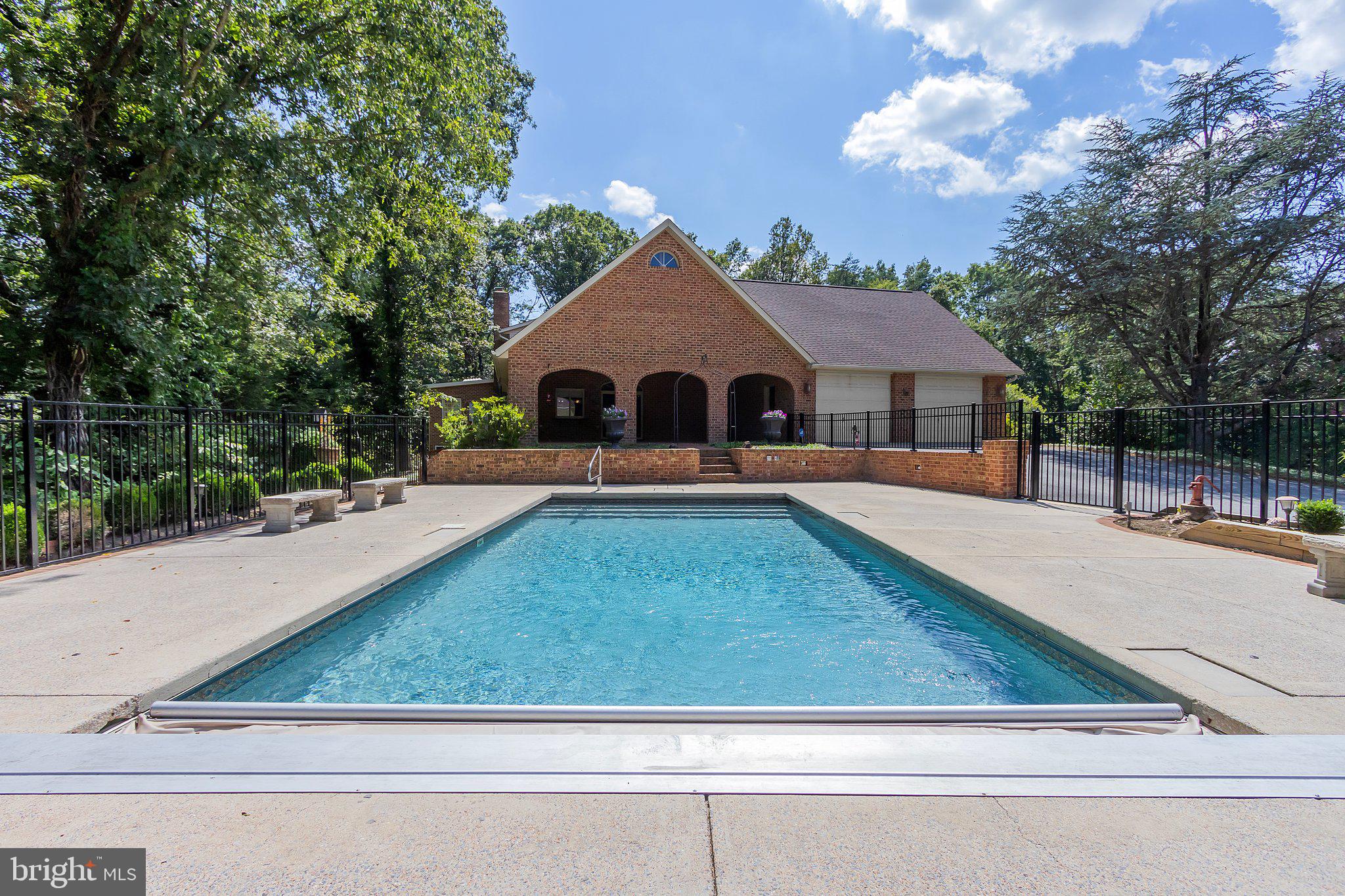 Welcome to your private sanctuary, a stunning custom-built Cape Cod masterpiece that spans over 8,000 square feet and sits gracefully on a sprawling 3.2 acre lot along a serene road with only one neighboring home. This is the tranquil oasis you've long sought after.
The outdoor space is nothing short of spectacular, featuring a spacious covered patio that invites gatherings of any size. The in-ground pool, equipped with an electronic cover for convenience, is surrounded by thoughtfully landscaped grounds, complete with shade trees that enhance the serene atmosphere.
Every inch of this home has been meticulously designed, from the exquisite hardwood flooring to the elegant crown molding, and the lush greenery. The gourmet kitchen boasts a brand new bowl sink, faucet and trash compactor, luxurious granite countertops, and an abundance of cabinetry, perfect for culinary enthusiasts. Updates include new wall oven, microwave and of course new whole house A/C.
The main floor is highlighted by a sumptuous primary suite, complete with a rejuvenating Jacuzzi tub and a generous walk-in closet. A well-appointed laundry room and a spacious home office make remote work a delight, especially with Comcast high-speed internet readily available.
You'll find yourself enchanted by the sunroom, where expansive windows bathe the space in natural light. It served as a green haven for plants, featuring a dedicated sink for easy upkeep.
Upstairs, four additional generously sized bedrooms and two full bathrooms ensure ample accommodations for family or guests. Storage will never be an issue, with a vast basement offering over 3,000 square feet of possibilities.
For those with multiple vehicles, the property features an attached two-car garage as well as a remarkable three-level Carriage House that can house four more cars, complete with an extra bathroom conveniently located near the pool area.
All of this magnificence comes without the burden of homeowners association fees or dues. Experience the epitome of luxurious living in this exceptional home!
