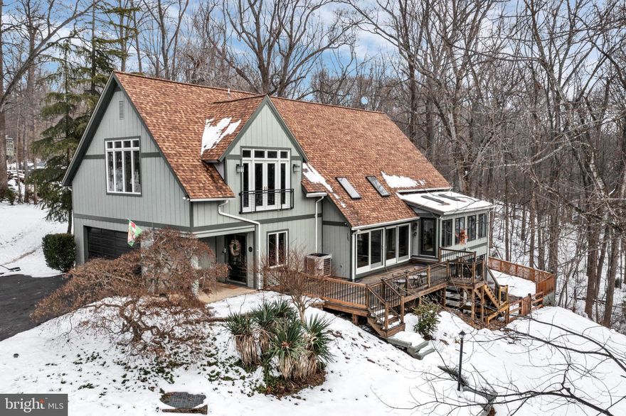 Welcome to 14225 Poplar Hill Dr, a truly exceptional custom estate offering unparalleled luxury. Set on a pristine 10+ acre lot, accompanied by an additional side lot of lush greenery, this home is nestled in the prestigious Spring Meadows/Harlow community. The property strikes the perfect balance between privacy, comfort, and convenience—ideal for those who seek a serene sanctuary with easy access to everyday amenities. Situated at the end of a private, newly paved driveway, you are greeted by a covered foyer, with one side featuring an accent wall and the other framed by expansive windows, creating the ideal mudroom space. Inside, the home’s open floor plan is highlighted by soaring ceilings, oversized windows, and skylights that flood the space with natural light. The spacious two-level design ensures a seamless flow for both daily living and entertaining. The kitchen, bathed in natural light from three large windows offering stunning views of the property, is a chef's dream. It features sleek Silestone countertops, recessed-panel cabinetry, brand-new stainless steel appliances, a coffee bar, and a pantry with updated sliding doors. The kitchen opens into a bright sunroom with wall-to-wall windows, providing the perfect setting to relax while enjoying views of the surrounding woods. The formal dining area, with its trio of windows and additional china storage, is complemented by a powder room and convenient laundry space. The family room is a showstopper, with vaulted ceilings, exposed beams, and a skylight.  A soapstone hearth frames the fireplace, with a decorative stone surround and a wood mantle adding further elegance.  The sunroom opens to a large fenced-in backyard, ideal and safe for children and pets.    The two-story living room brings the outdoors in, with sliding doors that open to a raised deck—ideal for entertaining or simply enjoying the serene landscape. Upstairs, the open hardwood staircase leads to the private quarters, where the luxurious primary suite awaits. With soaring 12-foot ceilings, French doors, and a wall of windows, this tranquil retreat also includes his-and-her walk-in closets with custom built-in shelving. The spa-like primary bathroom boasts a soaking tub with jets, a separate shower, a double vanity with custom cabinetry, intricate tilework, and large casement windows for natural light. Two additional generously sized bedrooms with hardwood floors share a beautifully renovated full bathroom. The fully finished lower level offers even more versatile living space, including a fourth bedroom, a third full bathroom, a theater room, an office, and a sunroom/exercise room. The recreation room, with its cozy fireplace, is perfect for casual gatherings, while the fourth bedroom, with tall windows and a sliding door to the sunroom, enjoys plenty of natural light. The lower-level bathroom, featuring two separate vanities and toilets, adds further convenience. The office, with custom built-ins and large windows, opens to a flagstone walkway leading to a stunning stone wall at the rear of the property. The bright sunroom offers flexible space, with wall-to-wall windows and access to the lower deck. Outside, the 10-acre property is a private retreat with trails, a creek, a hidden meadow, and abundant wildlife. This estate is the epitome of luxury and leisure, offering every amenity for an elevated lifestyle. With over 10 acres of tranquil landscape, this property is a true sanctuary of refined living—just minutes from the city, where every detail has been thoughtfully crafted for elegance and comfort.