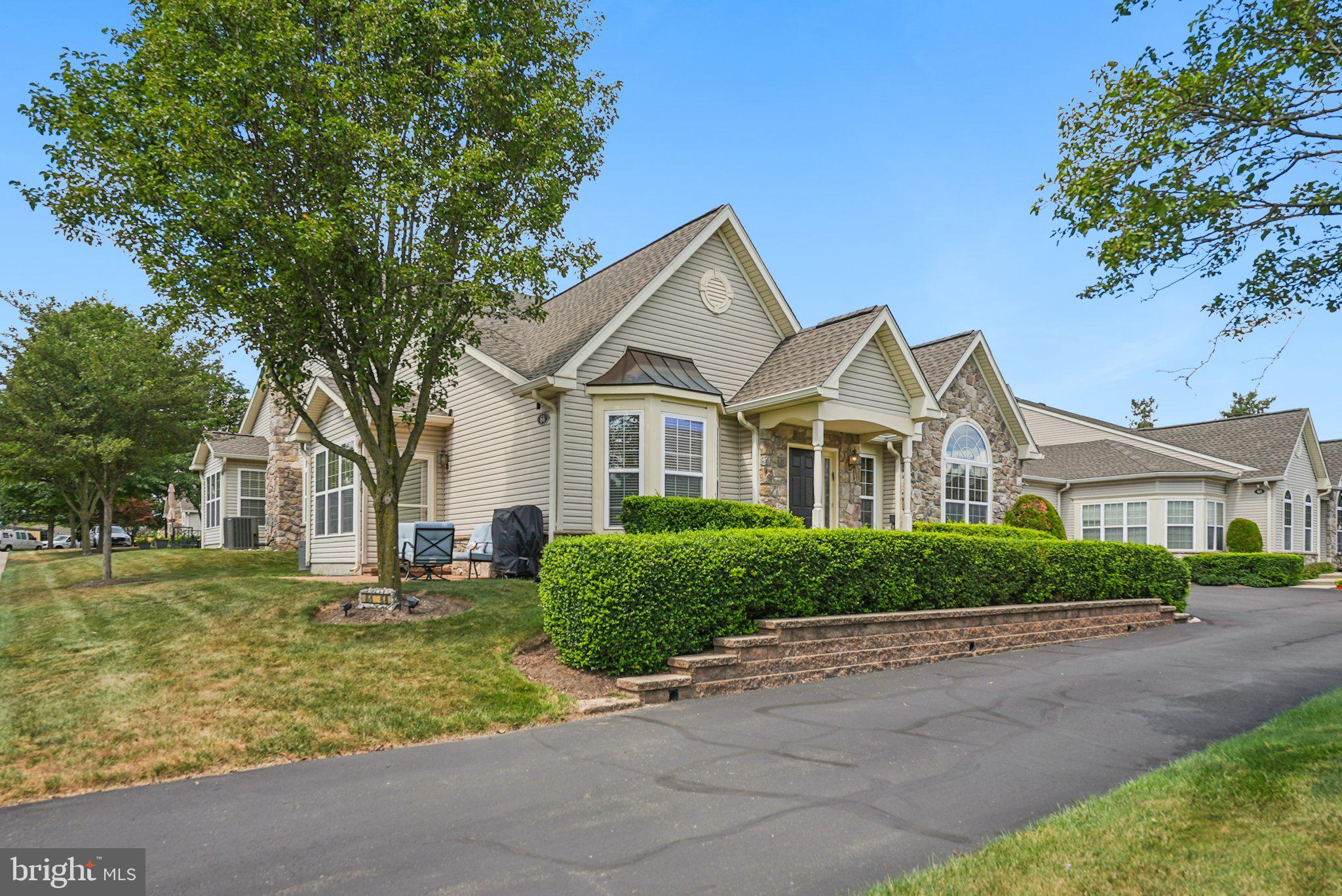Tucked into the lush enclave of The Villas at Five Ponds, this beautifully appointed carriage home offers leisurely resort-style living. Designed for those who value both comfort and connection, it is part of a thoughtfully planned 55+ community developed by McGrath Homes where a vibrant social rhythm defines daily life. The home itself unfolds with graceful proportions, attractive flooring, and loads of natural light. Rooms are generously open to one another for easy conversation. Formal spaces are complemented by both a family room and a sunroom and the kitchen has both counter and casual seating. Two spacious bedrooms and two full bathrooms anchor the main level, while a generous second-floor loft adds dimension and possibility. A separate bonus room, ideal as a guest suite, office, or personal gym, adjoins an added half bath, with plumbing roughed in for a future shower. Soaring ceilings and big windows make this home feel especially cheerful. A two-car garage keeps the driveway clear and adds extra storage. This conveniently located community’s amenities rival those of a private resort. Residents enjoy access to indoor and outdoor pools, tennis and pickleball courts, shuffleboard, basketball, and a clubhouse. Game rooms, a fitness center, billiards, a library, and party spaces foster connection and wellness year-round while the adjacent Five Ponds Golf Course makes it easy to spend an afternoon on the green.