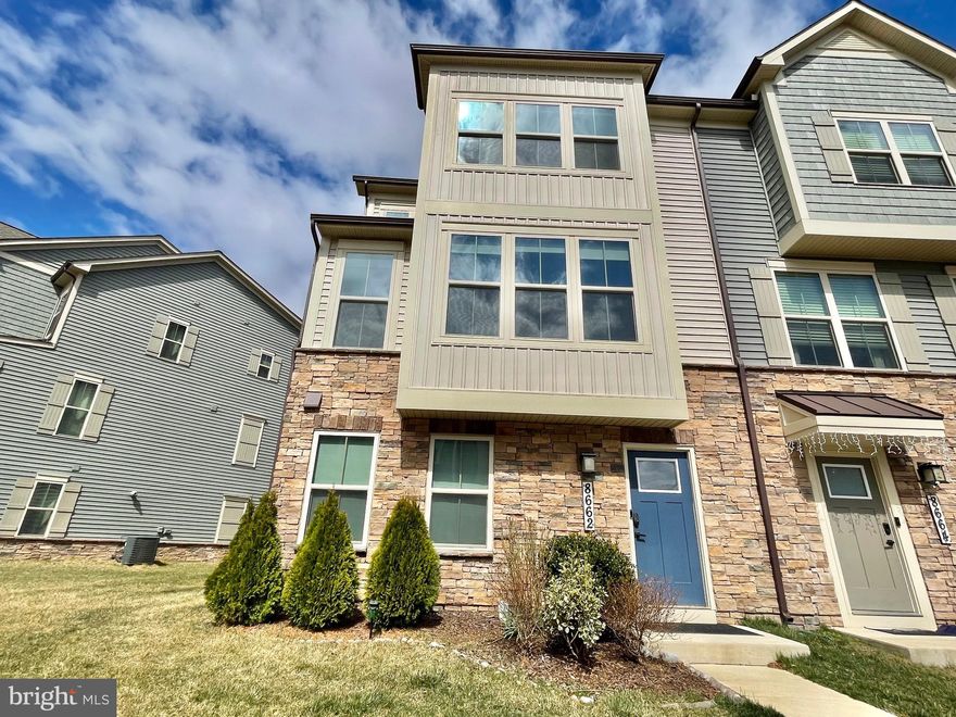 For Rent 2025! Welcome to Stone Barn Villages of Urbana, where luxury living meets convenience in the top-rated Urbana School District. This Stunning Serenade Model end unit townhome, modern elegance with this like-new townhome, featuring 4 Bedrooms, 3.5 Baths, and a 2-car attached garage, nestled in a vibrant community with exceptional amenities. This home offers an updated extended outdoor living with a covered deck included. Oak stairs leading to the main level with LVP flooring throughout. A luxury kitchen, dining room, great room, rec/office room, and extra windows that flood the home with natural light. The open concept layout provides the ideal space for entertaining guests or enjoying quality time with family. The upper level showcases a luxury kitchen equipped with custom cabinets, a large island, pendant lights, quartz counters, stainless steel appliances, pantry and half bath. Adjacent is the dining room with access to the outdoor living covered deck, a spacious great room, recessed lights, and luxury vinyl plank floors. Ascending to the upper level, you'll find the primary bedroom suite featuring tray ceilings, a sizable walk-in closet, and an en-suite bathroom with dual vanities and a walk-in shower with a seat. The two additional spacious bedrooms with generous closets, a full bathroom, and the laundry complete this level. The entrance level offers a foyer, hall closet, rec/office room (which could be converted into a fourth bedroom), a half bath, and access to the garage. This award-winning, masterfully planned community features: 3 parks, 3 pools (lazy river, fountain and slides), 3 community centers, 6 tennis courts, 3 basketball courts, pickleball, 18 tot lots, and miles of walking paths. Residents also enjoy access to the newest walk-able Stone Barn Village Community featuring a community clubhouse, recreation barn, pool, Sugarloaf Elementary and Goddard Schools. Conveniently located with easy access to major highways, local shopping, dining options, a farmer's market, YMCA and the library, this home truly offers the best of both worlds - luxury living in a prime location. Residents of this community enjoy access to a host of amenities, including a swimming pool, a well-equipped community gym, and proximity to local schools, grocery stores, and restaurants. This townhome’s location also makes it a great choice for commuters, offering easy access to major routes. This property represents a perfect blend of modern living, convenience, and luxury, making it an ideal choice for anyone looking to move into a home with all the benefits of community living and none of the wait of new construction. Embrace a lifestyle of convenience and style in a home that feels like new. This community is just off rt 270, rt 70 and minutes from downtown Frederick as well as tons of shopping, dining, hiking, biking and adventuring! The community has multiple playgrounds, ball fields and a skate park as well as plenty of green space. This home and area have it all!!