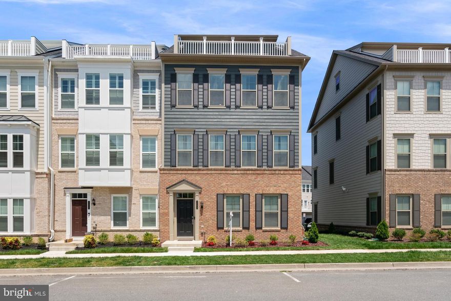 24 foot wide end unit two car garage townhouse built by Pulte Homes in the future town center district. Owners transfer your gain.  Immediate delivery possible. This home is loaded with gorgeous high end lighting, and ceiling fans, stunning white counters, marble backsplash from counter to ceiling, and around the breakfast bar. Extra cabinets over the buffet counter, wet bar on 4th level, all the roof top terrace furniture conveys, as well as all the appliances and the washer, dryer.  Look at the competition, and I promise you this home will be the one you want to buy.  This is a 3 bedrooms, 3.5 bath townhouse with a rear two car garage. There is extra storage racks in garage as well. Owners are motivated. Come see it today.  Best of all Potomac Shores is a resort style community featuring  The Shores Club ( where residents gather, party, have use of the gym and two pools.  The $200 HOA Fee includes the pool, gym,150/150 Internet, five miles of nature trails, two community schools and elementary, and brand new middle school. Potomac Shores is also home to the  only public Signature Jack Nicklaus   golf course in the Northern Virginia area. Walk to go play golf. Stop into the Tidewater Grill for dinner, or a happy hour to catch a sunset around the fire-pit.  This townhouse is located in the Potomac Shores Town Center district. Soon there will be a VRE Station as well as a day-to night town center.  This could be your new home!