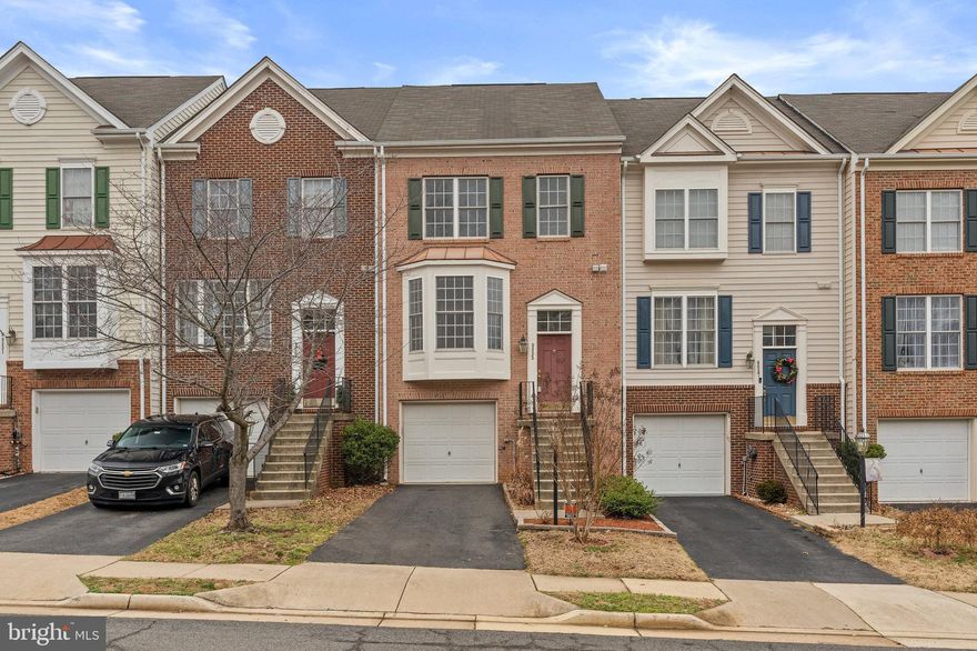 Welcome Home! Delightfully Charming and Remarkably Spacious Townhome in Manassas! Centrally situated in the highly desirable community of Hensley Ridge (Townes of Compton Farm), this 3BR/2 Full Bath and 2 Half Bath, 2,534sqft residence encapsulates sheer sophistication with beautiful colonial architecture, neat landscaping, and attractive exterior bricks. Sensationally styled to satisfy modern desires, the welcoming interior dazzles with an organically flowing floorplan, a neutral color scheme, gorgeous hardwood flooring, tons of shimmering natural light, and a sizeable living room. Catering to easy entertaining, the kitchen features laminate countertops, ample wood cabinetry, a range/oven, refrigerator, a built-in microwave, a dishwasher, and an adjoining dining area.  Host holiday parties or movie night in the fully finished lower-level with a huge rec room, recessed lighting, soft carpet, and a fireplace. Magnificently relaxing, the oversized primary bedroom includes a deep closet and an attached en suite with a soaking tub, dual sinks, and a separate shower. All additional bedrooms are abundantly sized with dedicated closets and may also be ideal for home offices or lifestyle-specific flex spaces. Other features: attached 1-car garage, laundry area, bump outs on all 3 levels and only 27.3-miles from Dulles International Airport, only 40-miles from Washington D.C., close to shopping, restaurants, and schools, and more! Call now to schedule your private tour!