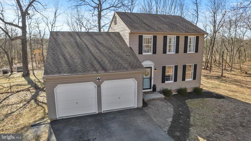 This beautiful 3 bedroom, 2.5 bath colonial sits on a 1.75 acre private wooded lot!  Wait to you see the finishing touches  of the tastefully upgraded home.  Sunken living room with open floorpan to the kitchen and breakfast area.  Bright crisp kitchen has granite counter tops, tin back splash, upgraded light fixtures, and stainless steel appliances.  Sliding glass doors off of breakfast area leading to deck to privately enjoy the outdoors.  Separate dining area open to large formal living room.  This home is great for entertaining!  Bamboo floors and ceramic throughout lower level.  Upper level includes master suite with updated master bathroom with walk in closet.  Two additional bedrooms and full bath on the second level.  Unfinished basement could be finished the way you want for additional living area! Two car garage, fenced in rear yard, and a lot that you will love are the additional perks of this home! Don't miss this one!