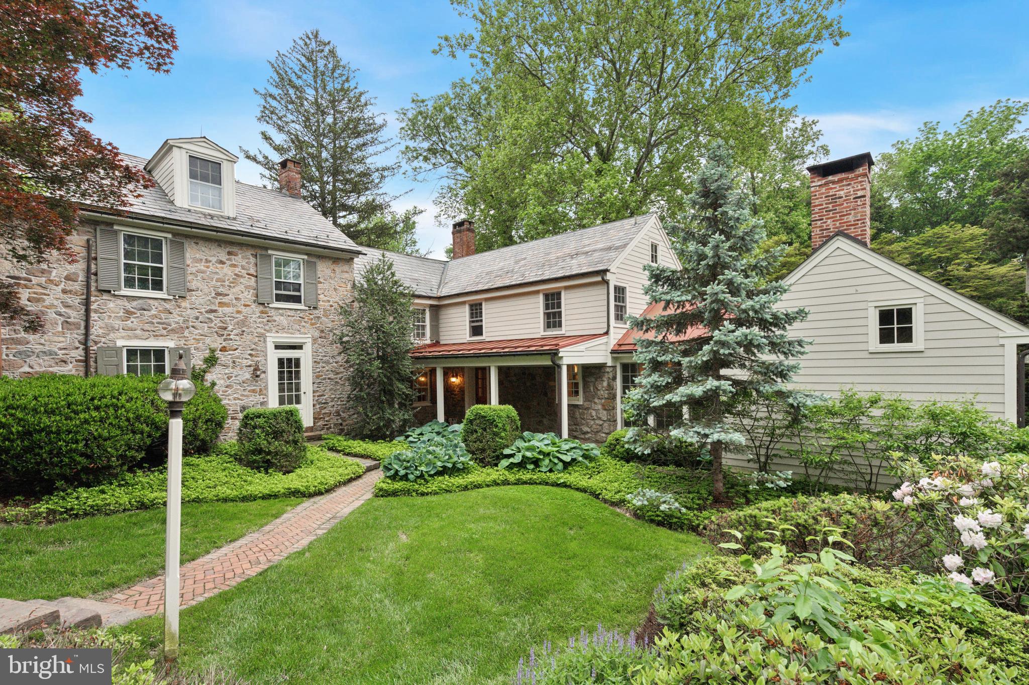 Welcome to 2320 Turk Road, a timeless Bucks County farmhouse estate. Nestled on a
sprawling lot set back from the road, this exceptional home is one of the most beautifully
restored historic properties in the region. Newly renovated, it offers complete privacy,
classic character, and turn-key luxury. The elegant 3-bedroom, 3.5-bath main(approximately 3,494 sq ft,
the 2nd bedroom so large that you could put up a wall to form a fourth bedroom) residence with pool is accompanied by a 2-bedroom carriage house(approximately 1,200 sq ft), original stone bank barn, and
picturesque spring house — all surrounded by rolling lawns and mature trees, creating a
tranquil country retreat on 4.7 Acres.
Dating to the late 18th /early 19th century, the main house masterfully balances preserved
heritage with modern comfort. Gorgeous wide-plank floors, three working wood-burning
fireplaces, and period details are paired with updated mechanicals, new central air, and
reinforced infrastructure for contemporary living.
Inside, you’ll find a gracious side entrance and mudroom, leading to a custom kitchen
that blends timeless style with functionality. Soapstone counters, high-end appliances
(Wolf, Sub-Zero, Fisher & Paykel), and a sunlit dining/lounge area are surrounded by
windows — including a newly installed picture window — that flood the space with
natural light and showcase panoramic views on all sides. Rustic ceiling beams and a
wood-burning fireplace add warmth and charm.
Adjacent rooms include a cozy formal dining room with a fireplace, an elegant entry foyer,
and a grand living room with traditional woodwork and a stone hearth.
The second floor features the primary and secondary bedrooms, a walk-in closet,
laundry, and two full baths — including a completely transformed primary bath offering a
spa-like experience. The third floor, fully renovated, has a bright, airy bedroom and en-
suite bathroom with handcrafted zellige tiles, creating a serene retreat.
Beyond the meticulous design and aesthetics, additional functional and mechanical
updates include new central air-conditioning, new roofing and repointed stonework. A new full-property generator services all three outbuildings, providing uninterrupted comfort and reliability.
The carriage house, a fully renovated 2-bedroom guest residence, features new skylights, HVAC/central air, updated electrical, a new hot water heater, and a new roof. Every detail — from the appliances to the finishes — has been upgraded, making it ideal for extended guests, caretakers, au pair quarters, or other flexible use.
A newly sheet-rocked garage completes this versatile structure. The original two-level bank barn, currently used as a gym with additional large flex space, has a new boiler and repointed masonry to ensure its structural integrity —offering endless possibilities for a home office, studio, or retreat space.
Outdoors, the meticulously landscaped grounds include a newly fenced pool area and terrace, offering a peaceful setting for relaxation. The wooded backyard, with a stream that could be turned into a natural pond, adds to the serenity. Over 60 large evergreen trees have been recently planted along the perimeter, ensuring privacy and a beautiful year-round natural border.
This is a rare opportunity to own a piece of Bucks County history, a bucolic sanctuary in the heart of Doylestown – just 78 minutes to Manhattan and under an hour to Philadelphia. More than a residence, this property is a warm and welcoming home steeped in history, offering classic elegance and modern luxury in one of the area’s most enchanting settings.