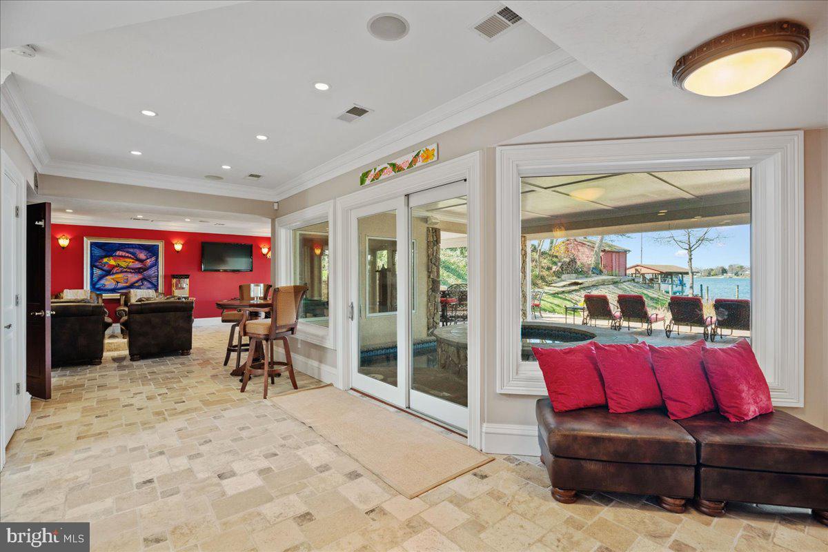 DELUXE WATERFRONT awaits your summer plans! Bring the party to this expertly crafted 4843 sqft Mediterranean style home on Mill Creek near Solomons. The private pier can host multiple sized power and sail boats, with 2 slips and water depth of approximately 8' MLW, 50 amp shore power. The stylish residence presents beautifully, and will satisfy even the most expectant of guests! Enter through custom mahogany doors, lock eyes with the private pier and Mill Creek vista, admire the exotic 'bubinga' flooring, and the open living plan. During the design process, the Seller chose luxury features and top-tier systems, included an elevator, prepared for future additions such as outdoor kitchen, lawn irrigation, etc. The living spaces are flanked by outdoor decking areas to extend the options for seating and dining. Built-ins, big windows, propane fire log stoves are perfect for cozy winter eves. The kitchen is one of the most luxurious spaces, with travertine floors, Subzero + Wolf + Miele appliances, crafted inset cabinetry, overall an unforgettable entertaining space plan with high-grade granite. The primary suite spans the entire mid-level, delivers owner lifestyle expectations: show-stopper creek views, two private balconies, owner's lounge with wet bar+ beverage center, two large closets, personal laundry, a luxurious owner bathroom with spa tub and dual shower with body sprays, extensive vanity space, heated travertine floors. The top floor includes 3 large bedroom suites, each with big windows to enjoy the creek views, each with custom ensuite baths, and more exquisite choices. THE FUN SPACE. The entire ground level is dedicated to entertainment on the waterfront for all ages. Enjoy Mill Creek views from the entire level, bring your friends to the best party space on the creek! The custom spa and saltwater plunge pool are under cover, private, and central to this level...perfect for use in all 4 seasons. Everyone will have an amazing experience here. Enjoy boating on the creek, head to Solomons Island for dinner...and at the end of the day you will enjoy the media space, a game of pool, toast the day with a night cap at the incredible custom bar room...loaded with more luxurious features! Get ready for summer!