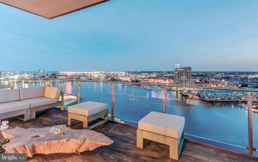 Welcome to the Four Seasons Private Residences in the heart of Harbor East, where luxury, location, and lifestyle converge.  From the 23rd floor, this gorgeous 2-bedroom, 2.5-bathroom residence offers spectacular  views of the Inner Harbor and marina and the Baltimore city skyline through  floor-to-ceiling windows.  This refined residence features rich walnut herringbone flooring, a gas fireplace, and high-end finishes throughout. The gourmet kitchen is outfitted with elegant cabinetry, a gas cooktop, wall oven, huge island with breakfast bar, and elegant quartz countertops. The adjacent dining area and wet bar with sink and wine fridge are ideal for entertaining or for a quiet night at home.  The primary suite includes a custom walk-in closet and a luxurious marble bathroom with double sinks, a large soaking tub, and separate shower. A second bedroom, also nicely sized, offers comfort and privacy for guests or family.
Enjoy your morning coffee or evening wine on the private balcony, and enjoy the shimmering waterfront and Baltimore skyline.  As a resident, you’ll have exclusive access to the private 28th-floor amenity level featuring an indoor saltwater infinity pool, sauna, outdoor deck, fitness center, meeting rooms, and lounging areas — plus a dog-walking area for your furry family members.  You’ll also enjoy full access to all hotel amenities, including the outdoor pool and valet services.  This property comes with one dedicated parking space in the garage with easy resident access.   The Four Seasons features four on-site restaurants, and many amazing dining options just a short walk away in Harbor East and Fells Point.  Shopping, parks, harbor activities, museums, and miles scenic waterfront walkways are all close enough to enjoy every day.  Experience luxury living at the Four Seasons, it’s more than a residence, it’s a lifestyle.