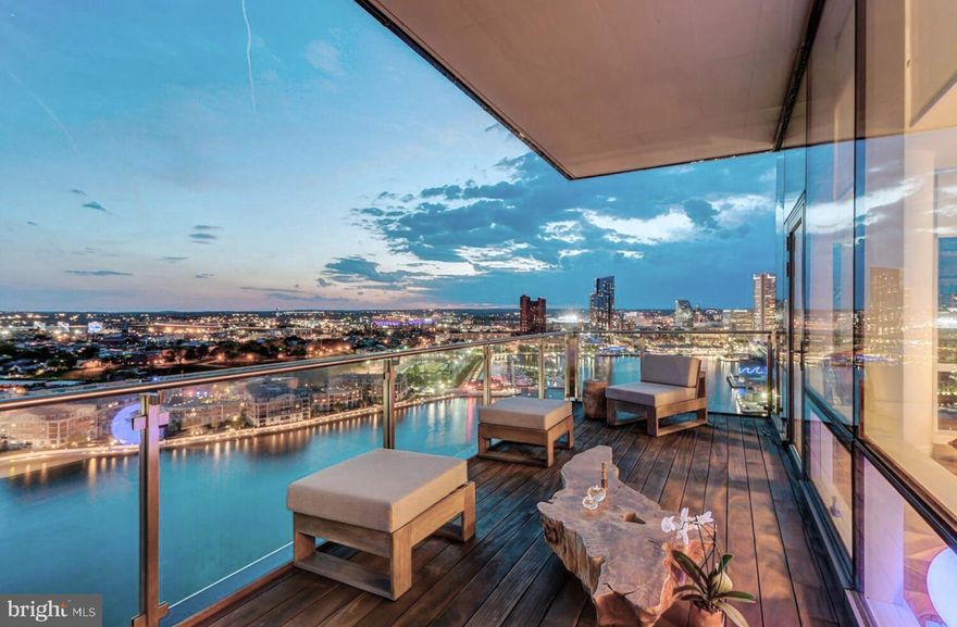 Welcome to the Four Seasons Private Residences in the heart of Harbor East, where luxury, location, and lifestyle converge.  From the 23rd floor, this gorgeous 2-bedroom, 2.5-bathroom residence offers spectacular  views of the Inner Harbor and marina and the Baltimore city skyline through  floor-to-ceiling windows.  This refined residence features rich walnut herringbone flooring, a gas fireplace, and high-end finishes throughout. The gourmet kitchen is outfitted with elegant cabinetry, a gas cooktop, wall oven, huge island with breakfast bar, and elegant quartz countertops. The adjacent dining area and wet bar with sink and wine fridge are ideal for entertaining or for a quiet night at home.  The primary suite includes a custom walk-in closet and a luxurious marble bathroom with double sinks, a large soaking tub, and separate shower. A second bedroom, also nicely sized, offers comfort and privacy for guests or family.
Enjoy your morning coffee or evening wine on the private balcony, and enjoy the shimmering waterfront and Baltimore skyline.  As a resident, you’ll have exclusive access to the private 28th-floor amenity level featuring an indoor saltwater infinity pool, sauna, outdoor deck, fitness center, meeting rooms, and lounging areas — plus a dog-walking area for your furry family members.  You’ll also enjoy full access to all hotel amenities, including the outdoor pool and valet services.  This property comes with one dedicated parking space in the garage with easy resident access.   The Four Seasons features four on-site restaurants, and many amazing dining options just a short walk away in Harbor East and Fells Point.  Shopping, parks, harbor activities, museums, and miles scenic waterfront walkways are all close enough to enjoy every day.  Experience luxury living at the Four Seasons, it’s more than a residence, it’s a lifestyle.