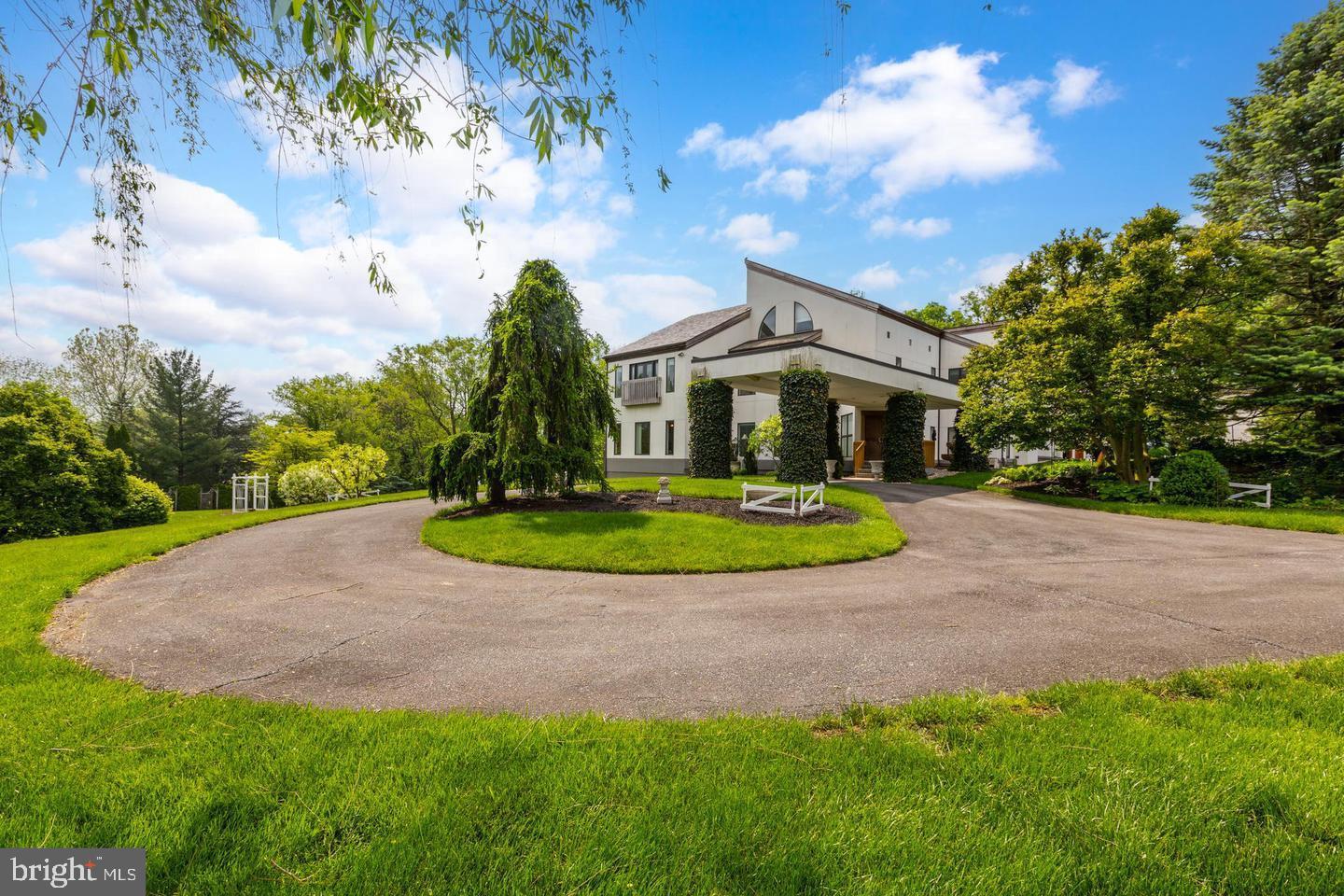 Welcome to this stunning, private West Lampeter Township property in scenic Lancaster County Pennsylvania. Situated on 7.2 acres, this 6700 square foot home offers plenty of room with 4 bedrooms, 3 full baths, and 2 half baths, plus garage space for 7+ cars. As you step through the custom-made teak front doors, you are greeted by a gorgeous white interior complemented by greenery and fine wood details. The minimalist stylings of this home are on full display in the kitchen which glows with the rich, natural light that filters through the windows and looks out over the luscious gardens and gazebo. Large dinner parties? No problem in the oversize main dining room, or even relax entertaining in the luxury of your formal living room, or on the privacy of your custom deck overlooking the beautiful pond and gardens, the perfect spot for capturing photos while spending time with family and friends. At the end of a long day, retreat to your spacious primary bedroom on the second floor, accessible via stairs or your very own elevator. This primary bedroom offers plenty of space to have your own sitting area and features a substantial walk-in closet, a beautiful bathroom complete with dual sinks, a jacuzzi tub, a walk-in shower, a bidet, and striking marble finishes. With three additional bedrooms and two full baths, you have plenty of room for family or visiting guests. Also conveniently located on the bedroom level is a full laundry room complete with plenty of custom storage. The third-floor loft offers an inviting space for an office, yoga/meditation area, or just a place to escape and enjoy a good book. As you make your way through your home to the main 3-car garage you pass by an amazing pantry/storage area with plenty of custom storage, pull-out drawers, and interior lighting. This amazing home doesn't end here. There are two oversize areas that currently are used as a both an office area and staging/product staging/photography area. These areas make great space for an in-home business or could be converted to in-law quarters. Above the four-car garage is an unfinished space offering additional storage. This home offers more than can be stated here in this description. Schedule your very own private tour of this magical home today.