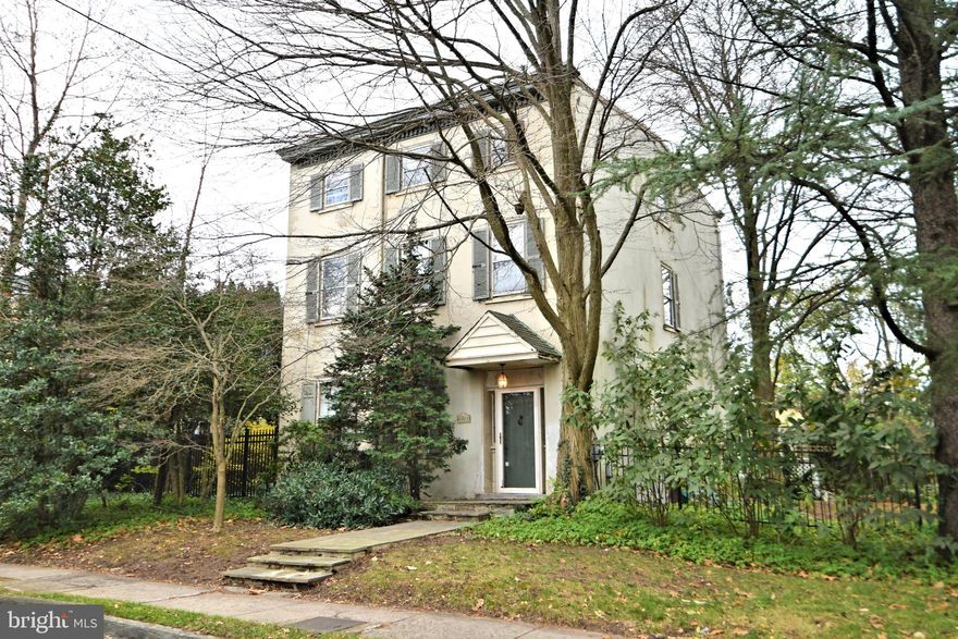 Welcome to 8828 Germantown Ave , Chestnut Hill.   This stately home offers 3 floors of  historic charm in the perfect location. A lovely corner lot that's a comfortable walk to the heart of the village, quaint main street shopping and  diverse array of restaurants.  Built in 1850 this home has  generous sized rooms all with 14 foot ceilings, original crown moldings and deep window sills throughout.  The large period foyer welcomes you in and the stunning staircase begs you to explore the floors above.  The first floor offers a large living area with 2 fireplaces, a dining room with built ins and French doors to the very private, pool courtyard. Moving on, we find a nice sized updated kitchen with access to the 2 car garage.   Upstairs the second floor offers 3 very large bedrooms, primary with ensuite, hall bath and dedicated laundry with original built ins.  Continue up to the 3rd floor and find 2 enormous bedrooms and equally abundant hall bath.  The back room offers a small parapet balcony looking over the fully fenced and secure 1/4 acre.  Private driveway, new state of the art heating and central air.  This home just needs the one buyer and the TLC it needs to restore it to its original glory. The recent price adjustment includes consideration for possible renovations to this wonderful home.