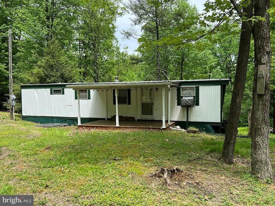 Looking for a private retreat or wooded get-away? This is a must see! This two bedroom, one bath mobile home on 1.45 acres is just what you have been looking for! Listen to the small stream out back, relax and take in nature! This property does have a well and a septic so it could be your full time residence!