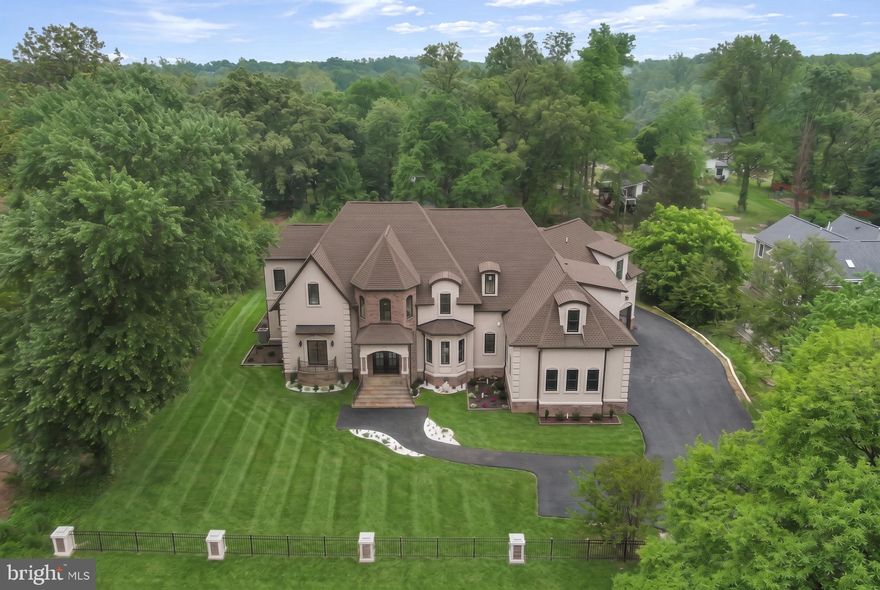 3D VIRTUAL TOUR - ASK YOUR AGENT FOR TOUR LINK  - Extraordinary custom estate built in 2025 - 7 bedrooms and 7.5 baths with 11,624 square feet of luxurious living space. Thoughtfully designed with custom molding and elegant tray ceilings throughout. Impressive ceiling heights with 10FT ceilings on the main level, 9FT on the upper and basement levels, and 16FT ceiling in the library/living room. The open and versatile floor plan is ideal for large-scale entertaining, featuring a formal dining room, breakfast nook, spacious gathering room, private office, and an upper-level wet bar. Gourmet kitchen is appointed with two marble countertop islands, gas cooking, and seamless flow into the main living areas. A standout feature is the private 3-bedroom, 2 full bath IN-LAW SUITE with its own kitchen—perfect for guest house or potential rental income. Walkout basement adds valuable living space, complete with a full wet bar. Additional highlights include two laundry rooms with full washer/dryer, two-zone HVAC, a grand side-entrance, and a four-car garage with ample parking. Situated on a private .94-acre lot, this home offers exceptional scale and luxury – a must see! Minutes to 95, 395 and 495. *Grass in photos is edited*