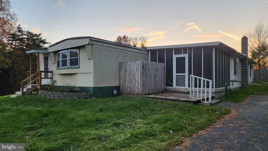 Spacious mobile home on 1.3  acres. Plenty of space  inside and out!   Screened in porch and great room with wood stove perfect for relaxing in Winter or Summer.  3 ample sized bedrooms with plenty of storage and outdoor sheds.  One bedroom is behind the kitchen and used to be its own efficiency apartment for extra privacy.  Pet allowed depending on size and breed with pet deposit and pet rent for certain breeds. Water is well and septic.