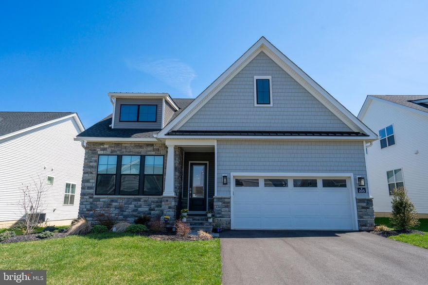 Welcome to 203 Gerry Way in Horsham Township, a stunning, nearly new luxury residence in the highly sought-after Regency at Waterside, a premier 55+ community built by Toll Brothers. This exceptional Junewood model offers the perfect blend of modern design, thoughtful upgrades, and effortless living… all without the wait of new construction. From the moment you arrive, the covered front porch with enhanced railing sets the tone. Step inside to a welcoming Foyer featuring rich hardwood flooring, recessed lighting, and soaring 10-foot ceilings that carry throughout the home, creating an open and airy feel. The ample Dining Room with double window and recessed lighting can also be used as an Office space (as currently utilized) and offers plenty of space for work, entertaining, or gathering. Step further inside the open-concept floor plan and you'll enter the heart of the home: the beautifully appointed eat-in kitchen designed to impress with a large quartz island with added storage, upgraded white cabinetry to the ceiling with gold accent hardware, crown molding and  tile backsplash, and stainless steel appliances including a KitchenAid gas cooktop, convection wall oven, and LG refrigerator. The bright Breakfast Area flows seamlessly into the spectacular Great Room, where hardwood floors, a gas fireplace, oversized windows, and custom window treatments create a warm yet elegant gathering space. The Great Room's sliding glass doors lead to an expansive covered composite deck with recessed lighting… perfect for relaxing or entertaining. The extended first-floor Primary Bedroom en-suite is a true retreat featuring hardwood flooring, crown molding, recessed lighting, ceiling fan, and a customized walk-in closet. The spa-like Primary Bath includes an extended tile shower, dual quartz vanity, large linen closet, and private water closet.  A seated vanity has been tastefully added to appear that it had always been there. A thoughtfully designed Laundry Room complete with tile floors, extra cabinetry, double hamper, utility sink, and GE Profile Washer and Dryer connects conveniently to both the Primary Bedroom closet and hallway.  Enter from the two-car garage with epoxy flooring into a custom designed mud space with hooks, shelving, and a bench. The nearby 2nd Bedroom (or Office), along with a 2nd first floor full Bath, offers flexibility for guests or work-from-home needs. Upstairs, you’ll find a generously sized Loft/Family Room with hardwood flooring, double window, and recessed lighting leading to a spacious 3rd Bedroom with good closet space. A full Bath with gorgeous vanity, handsome hardware, and tub shower rounds out the second floor, providing ideal space for guests or additional living. The large unfinished Basement with roughed-in plumbing offers endless possibilities for future expansion. Additional highlights include a security system and premium finishes throughout. Living in Regency at Waterside means enjoying resort-style amenities including a 10,000 square foot clubhouse, indoor and outdoor pools (recently converted to salt treatment), fitness center, pickleball and bocce courts, putting green, dog park, scenic walking and biking trails, and so much more! Conveniently located near all kinds of shopping and dining, The Promenade at Upper Dublin, as well as Costco, Wegmans, Sprouts, Trader Joe’s, and Whole Foods. Nearby Talamore, Squires, and Commonwealth Country Clubs provide plenty of practice for the golf enthusiast. Easy access to Routes 63, 463, 152, 611, and 309. Luxury, lifestyle, and location all come together seamlessly at this beautiful home. Come take a look before it's gone!