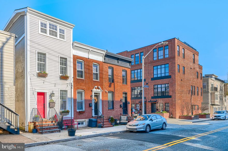 Experience the pinnacle of Canton living in this impeccably maintained residence, where classic Baltimore charm meets modern sophistication. The expansive, light-filled floor plan is punctuated by architectural tray ceilings, custom built-in bookshelves, and original exposed brick. Gleaming hardwoods guide you through the open living space to an intimate, private rear patio - your personal urban sanctuary. Upstairs, discover a sprawling primary suite along with two bedrooms and convenient laundry. The versatile lower level serves as a refined lounge or the ultimate executive home office. This is a turnkey masterpiece, perfectly positioned just steps from the vibrant heart of the neighborhood.