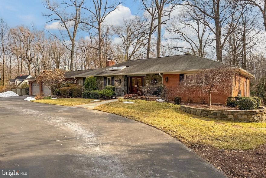 Discover this delightful, meticulous brick rambler with an attached two-car garage, perfectly situated on a generous almost acre lot, offering both charm and ample space for indoor and outdoor enjoyment.
A convenient circular driveway and charming walkway welcome you to the inviting front entryway where  gleaming hardwood floors  flow throughout the main level, creating a warm and inviting atmosphere.
The heart of the home is the large open-plan kitchen, featuring rich cherry cabinetry, high-end stainless steel appliances, a gas stovetop, and spacious central island; ideal for entertaining and casual gatherings. An adjoining dining room exudes ambiance with its stone wood-burning fireplace, perfect for cozy evenings, and access to the sunroom; a true highlight, boasting a fabulous picture window and direct access to the expansive stone patio and beautiful gardens beyond—an idyllic spot for morning coffee or evening relaxation.
Relax in the bright family room, complete with custom built-in cabinetry and an abundance of windows. 
A spacious formal living room impresses with elegant custom moldings, while the main-level guest bedroom offers a large closet and easy access to the hallway bathroom with shower-over-tub. The primary suite is a luxurious retreat, showcasing a custom arched ceiling, two generous walk-in closets, and a spa-like ensuite bathroom with abundant cabinetry for ultimate convenience.
Descend to the lower level for even more living space: a large storage room, an expansive recreation room with a convenient wet bar, and walkout access to the lower patio—ideal for entertaining, game nights, or quiet relaxation.  Two additional spacious bedrooms serve as the perfect private guest suite, or home gym, positioned next to their own hallway bathroom. Completing this level is a huge custom office with built-in cabinetry and plenty of windows, offering an inspiring workspace.
This exceptional home combines timeless charm, modern amenities, and versatile spaces for every lifestyle. Don't miss the opportunity to make it yours!
13 miles to DCA, 11 miles to the Pentagon, 9 miles to Dunn Loring metro, 7 miles to Springfield metro, easy access to I-495, I-395 and Rt 66.

Roof - 2014, Windows - 2009, HVAC - 2015 & 2009, Hot water heater - 2025