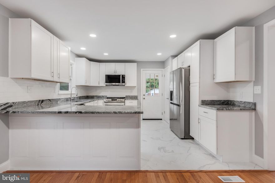 This fully remodeled split-foyer home is a true gem, offering elegance and modern comforts throughout. Nestled on a nearly half-acre corner lot, it features 5 spacious bedrooms and 3 luxurious, updated baths. The home showcases a brand-new roof, HVAC system, and driveway, with a stately brick exterior, carport, expansive deck, and a fenced yard that provides both privacy and space for outdoor enjoyment.

Step inside to discover a beautifully redesigned interior, highlighted by a stunning gourmet kitchen with sleek white cabinetry, stainless steel appliances, granite countertops, and recessed lighting. Gleaming hardwood floors flow seamlessly throughout the main level, and the home’s lower level is filled with natural light, offering a bright and welcoming family room complete with a cozy fireplace.

Perfectly located, this property is close to the vibrant Bowie Town Center, the scenic Watkins Regional Park, and popular attractions such as Six Flags America. With easy access to US-301 and I-495, commuting to Washington, D.C., National Harbor, and MGM is a breeze. This home combines style, convenience, and functionality for a truly extraordinary living experience.