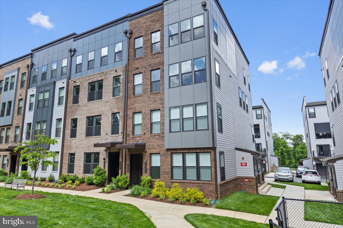 If you are craving a low-maintenance lifestyle with all the conveniences of access to main highways, restaurants, and shopping, this home is for you! Situated on the top two levels of the four-level townhome, this less than 3 year old end unit condo offers a spacious floor plan that is perfect for hosting. The first thing you'll notice as you enter the main level is the abundance of natural light flooding the home through the many windows (all dressed with automatic shades) . Luxury vinyl plank flooring on the main level provides continuity throughout the open family room, kitchen, and dining area. We all know the kitchen is the heart of the home, and with its position between the family room and dining area, this kitchen embodies that sentiment. An oversized island is the perfect gathering spot for friends and family while you're whipping up a gourmet meal. Quartz countertops, white cabinets, and stainless steel appliances provide a sleek, clean look. Rounding out the main level is a covered porch and powder room. On the upper level you'll find a generously sized primary suite complete with custom closet (a $10K update). Two secondary bedrooms, a hall bath, and laundry room finish out that level. But that's not all...if you continue up the stairs from the second level, you find an expansive rooftop deck providing an amazing oasis to relax and entertain. The 1 car garage and driveway provide parking for 2 cars, and if you have an electric vehicle, you're in luck! The garage is wired for an EV charger. Enjoy being on the interior of the neighborhood away from the road as you look over the green space that boasts a fire pit and tot lot. Commuting is a breeze with easy access to I-66, Hwy 50, and Hwy 29. Don't miss out on this impressive home!