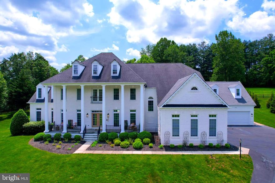 **When visiting this gorgeous property, please help us protect the manicured lawns by parking in the driveway or in the cul-de-sac, not along the pipestem.**

Welcome to 2506 Coulter Lane, an exquisite 1.72-acre estate in the tranquil enclave of Oakton, Virginia in the Madison High School pyramid. This magnificent residence offers six bedrooms and five and a half baths, providing abundant space for relaxation and entertainment. With over 11,000 square feet of meticulously crafted living space, this home epitomizes luxury and comfort.

A winding drive leads to the stately all-white brick facade of this classic home, complete with large columns, a full-width front porch with wrought iron railings, and a double front door. A recent addition brings the total garage space to five full bays.

Step inside to a grand two-story foyer that exudes warm luxury. The thoughtfully designed floor plan seamlessly integrates formal and informal living areas, creating an inviting atmosphere perfect for intimate gatherings and large-scale entertaining. Flanked by a stunning dining room with a tray ceiling and an expansive living room, the foyer leads to an elegant staircase with a central landing overlooking the pool. Adjacent to the living room is a sunroom spanning the home's depth, featuring floor-to-ceiling windows and tile floors—ideal for hosting guests or enjoying a personal retreat. The main floor office, overlooking the backyard, is tucked away for privacy and includes custom built-in cabinetry.

The open-concept main family area features a great room with floor-to-ceiling windows, a gas fireplace and built-in media cabinets It flows seamlessly into the chef's kitchen and large breakfast area, both overlooking the pool. Natural light floods this expansive area, highlighting elegant architectural details and refined finishes. The updated kitchen boasts Wolfe and Sub-Zero appliances, marble countertops, and a separate pantry closet. A generously sized mudroom and laundry room off the kitchen lead to the attached garage.

Upstairs, the grand primary suite serves as a private retreat, featuring a sitting area overlooking the pool and a private room above the carriage garage that is a versatile space, perfect as a reading room or workout area, complete with heated floors. The primary bathroom offers a marble-raised bathtub, two separate vanities, a beautiful walk-in shower, a separate water closet, and two walk-in closets. Each additional bedroom is generously sized, with luxurious en-suite bathrooms and walk-in closets, ensuring comfort and privacy for family members or guests.

The lower level includes the sixth bedroom with a full en-suite bathroom, walk-in closet, and walk-out access to the pool area. The fully finished workout room and storage room provide useful space, while the massive rec room/game room features a full kitchen and additional office space. The media/movie room promises countless movie and gaming night memories.

Outside, discover an oasis designed for entertaining and relaxation. The expansive patio area includes a bar, outdoor grill area, and tiered in-ground pool and spa, featuring a new heater, pump, and salination system for easy maintenance. The yard is fully enclosed with a custom metal fence. The newly added detached garage carriage house offers an ideal workspace for craftsmen or gearheads. The fully finished, conditioned space includes two 60-amp EV chargers for your electric vehicle needs. The home is serviced by a whole house back-up generator.

2506 Coulter Lane presents a rare opportunity to own a piece of luxury in one of Virginia's most sought-after areas. This estate is now available for sale, inviting you to make it your own. For more information or to schedule a private viewing, please contact us today.