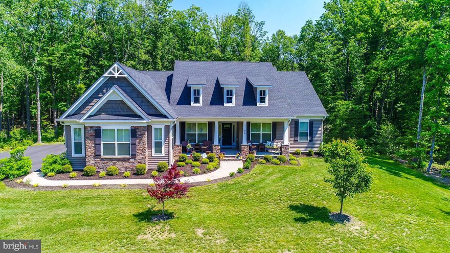 GREAT REDUCED PRICE ON THIS GORGEOUS HOME! MAIN  LEVEL living, bedrooms too! Home like new w/ PRIVACY! 2.68 Acres on a cul de sac plus  backs to PROTECTED ACRES behind you- see plat!  Quiet, trees, wildlife,patio, deck, built in hot tub, built in grill, speakers, lawn shed, parking-see finished pretty garage! Opens to Laundry w /W&D & sink plus space! Sunny front porch! Huge cathedral great rm w/ fpl-opens to upg kitch w/travertine, windows & deck! FAMILY island, upg. appliances, butler & walk in panty! Lg library! Owners suite is magnificent! Lux bath- stone & tile w/ walk in closet w/ window! 2 additional separate bedrooms Lower level is HUGE! Bedroom, bathroom, biggest family rm! You have a  bar w/ refrig!  Also set up for pool table!  Exercise room too! Storage is wonderful!! Home is beautiful & COMFORTABLE!