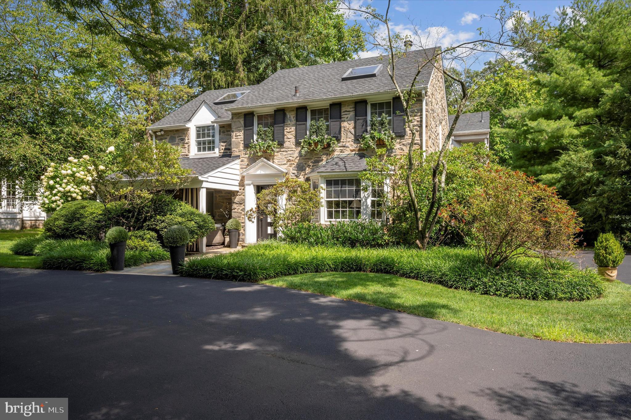 Introducing 909 Centennial Road, a captivating stone colonial home nestled in the highly sought-after neighborhood of Penn Valley within the award-winning Lower Merion Township. This remarkable property exudes timeless elegance and boasts a wealth of luxurious features.
As you approach this home you immediately see the inviting and charming Front Porch. You enter the home through the striking black and white architectural front door and you are greeted by the grandeur of rounded archways leading into a spacious dining room adorned with inlaid hardwood floors. The adjacent kitchen beckons with a breakfast room and a large island featuring a counter bar and creating the perfect setting for culinary delights and casual gatherings.
Co-listing agent is related to Seller
A few steps down you'll find a cozy family room adorned with a black marble fireplace and built-in floating shelves, all complemented by the allure of new Pella windows. The adjacent bar area, complete with a brass sink and mirrored shelves, offers a touch of sophistication while providing a seamless transition to the breathtaking view of the pool and expansive backyard.
The first floor also presents a powder room, a large coat closet, an office/den with elevator access, and a living room boasting a stone fireplace, brass and wood mantle, and large bay windows that bathe the space in natural light.
Ascending the open stairway with double brass railings to the second floor, you'll discover a thoughtfully designed layout that includes a series of beautifully appointed four bedrooms. The two very large bedroom both adorned with a skylight features a generously sized walk-in Jack and Jill closet, providing ample storage space and organizational convenience to meet your needs. The hall tiled bathroom, complete with a tub/shower and a window that infuses the space with natural light.The third bedroom, boasting a large closet and an elevator entrance, offers both comfort and practicality, making it a versatile space that can adapt to your specific needs. Conveniently located in the hallway is a laundry room and linen closet, featuring double bifold doors for easy access and discreet storage solutions, ensuring that daily chores are seamlessly integrated into your lifestyle. The master suite is a true sanctuary, featuring a platform bed, built-in nightstands and headboard, and an abundance of Pella windows offering panoramic views of the lush surroundings. The master bath is a luxurious retreat, adorned with marble detailing, a spacious jacuzzi with marble surround, a rejuvenating steam shower with a window and marble bench, and a super wide vanity with double sinks.
The lower level offers additional space for relaxation and entertainment, with a newly carpeted stairway leading to a versatile area that includes a cedar closet, an exercise room with an elevator entrance, a bedroom/playroom with a closet, a sauna, a full tile bath with a stall shower, and ample storage space.
The backyard is truly a haven for outdoor enjoyment and relaxation.The centerpiece of this outdoor oasis is the multi-level decks with an inviting pool, complete with a hot tub, offering the perfect setting for leisurely dips and unwinding.  Amidst the expansive grounds, you'll find ample space for recreation and fun, including a trampoline that promises hours of enjoyment for both children and the young at heart. The backyard offers endless opportunities to create cherished memories with family and friends.
This exceptional property also features an elevator installed just a few years ago which goes from the basement to the second floor, adding convenience and accessibility to its list of impressive attributes. There is also a generator.
With its enchanting blend of sophisticated charm and modern amenities, 909 Centennial Road is a rare gem in an amazing neighborhood with eazy access to Center City or KOP. Open House Thursday Feb 22nd 4-6pm.