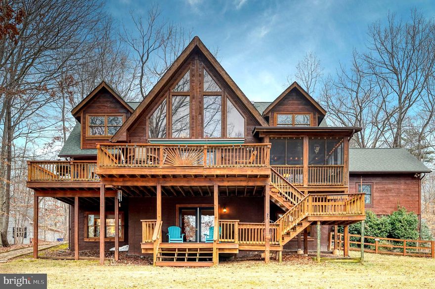 Welcome to your dream-come-true waterfront log home. This lovely 5 bdrm/3.5 ba custom home (3 bdrm septic) offers the prefect location (by land and water) with great views of the lake and the comfort and warmth of natural wood throughout. You'll see the lake immediately upon entry into the foyer and family room featuring 2-story windows, a corner stone hearthed wood stove, and a loft. Enjoy your morning coffee or evening drink on the attached screened porch or stroll along the concrete path to the screened porch on the dock where evening sunsets can be enjoyed. The main level primary bedroom overlooks the lake and includes a walk-in closet and en-suite. The gourmet kitchen offers a 5-burner gas cooktop and wall oven with convection microwave. Outdoor dining and lake enjoyment are ensured! This home features two over-sized bedrooms on the upper level with full hall bath. On the lower lake level, a generous sized family room offers the perfect hangout spot for family fun. Fourth and fifth bedrooms create lots of over-sized bonus space and can easily transition to the perfect opportunity for an office, game room or other options. This home also includes a 2-car attached garage and a free-standing storage shed.  A built-in humidifier system for the main HVAC unit and in-ground irrigation system are some of the many special features! PROFESSIONAL PICTURES TO BE POSTED AS OF MARCH 1, 2026.