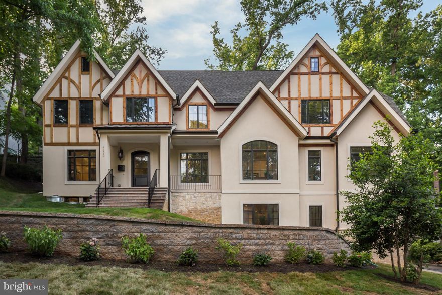 Majestic Tudor on a corner lot.  Top to bottom renovated and expanded home offers 7 bedrooms 6&1/2 baths , fabulous gourmet kitchen &  family room w/FP, finished lower level with wet bar and second family/game room w/FP plus a 2 car garage.  hwd frs, high ceilings, crown moldings, recessed lighting, a grand curved staircase boasts a crystal chandelier and more...This is a Jewel! Alarm code in LB