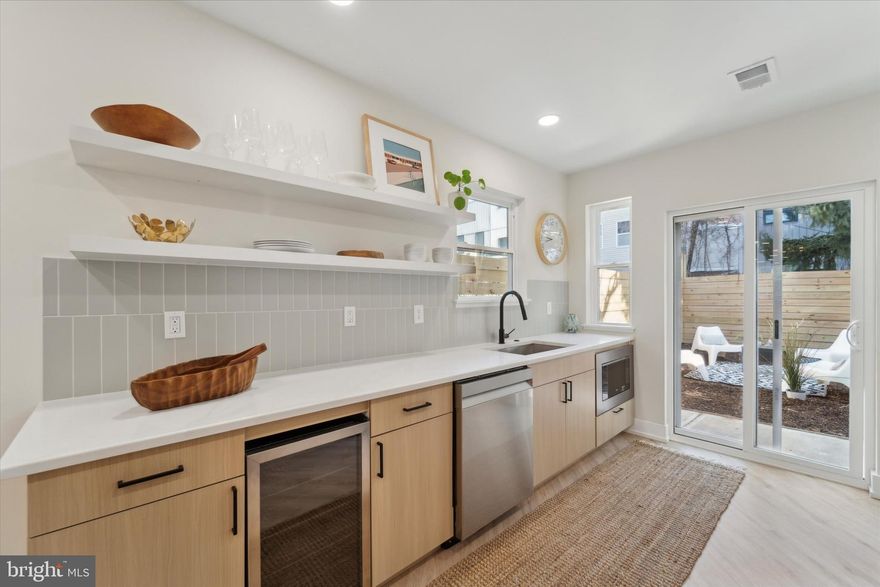 Welcome to your own sanctuary nestled in the most sought-after neighborhood in the City, Fishtown. This light and airy home will embrace you with peace and calm after a hard day's work. Enjoy quiet living just steps from the excitement and convenience of what Fishtown has to offer. Commuter? Easy as pie. Close proximity to major highways, numerous bus routes, and bike stations. You are walking distance all the amenities that Fishtown has to offer like restaurants, bars, café’s and shops. 
 
Enter the open living space, featuring a color palette that accentuates outstanding natural light from north, south, and west throughout the day. A half bath with a floating vanity is on the main level.. 
 
The dining and kitchen area is a large galley-style space with room for your farm table alongside the warm and cozy fireplace. The kitchen features, birch cabinetry, custom hardware, a wine fridge, stainless appliance suite, open shelving along with excellent natural light streaming through the sliding glass door that leads to the large back yard, ready for outdoor entertainment and relaxation. 
 
The second-floor living quarters include a primary suite at the rear of the home with a huge bedroom window overlooking the backyard, a large walk-in closet, and an en-suite bath. The front and middle bedrooms are generous, with enough space for a home office/guest room combination and a gorgeous shared bathroom. The second-floor bathroom has a clean crisp, understated color palette throughout, with a large window and a natural wood vanity. 
 
This home comes with a 10-year tax abatement, 10-year roof warranty, new plumbing, electrical, HVAC, and one-year builders warranty.