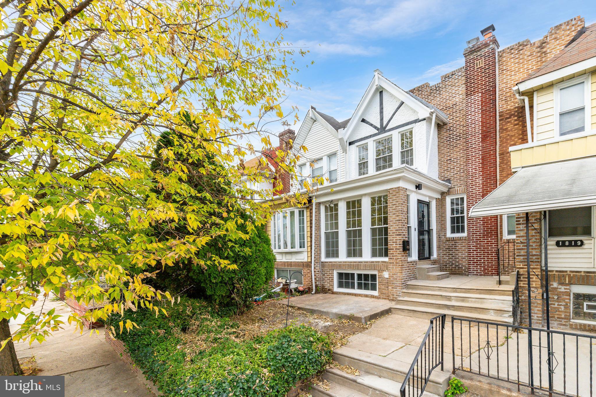 Beautifully renovated brick-front row situated on a quiet, tree-lined block in Ogontz. Arrive and you will immediately picture yourself relaxing on your front patio. Enter through the enclosed sunroom with new floor to ceiling windows that provide an array of natural light, and you will be in awe with the amazing renovation with attention to the details. The sunroom has French doors that lead to the main living area that has new LVP wood floors, wainscoting walls, corner fireplace enclosed with travertine and solid wood mantel, recessed lights, and sconces. Continue to find a formal dining room with chandelier, sconces, chair rail with wainscoting walls from floor to ceiling and an open concept to the dream kitchen complete with large format tiled floors, an abundance of shaker cabinets with Quartz countertops and Zellige tiled backsplash, farmhouse sink with chef style faucet and high end stainless steel appliances including 5-burner gas range, built in microwave and dishwasher, and French door refrigerator that is included. The upper level carries the LVP wood floors throughout and hosts 3 spacious bedrooms, all with nice ceiling fans and plenty of closet space, and spa-like 3-piece ceramic tile bathroom with shower/soaking tub combo with Zellige tiled surround and accent shelves, and a modern vanity with curved mirror and accent sconces. The lower level is a full basement that can be utilized as an additional living area or storage and has a separate laundry area with new washer and dryer that are included and exits to the 1-car garage and driveway that provides off-street parking. Located on a charming block in a quiet neighborhood, this home offers both tranquility and convenience being located close to Cherashore Park, schools, public transportation such as the Wister train station and Fern Rock transportation center, great restaurants, and shopping. Will not disappoint.