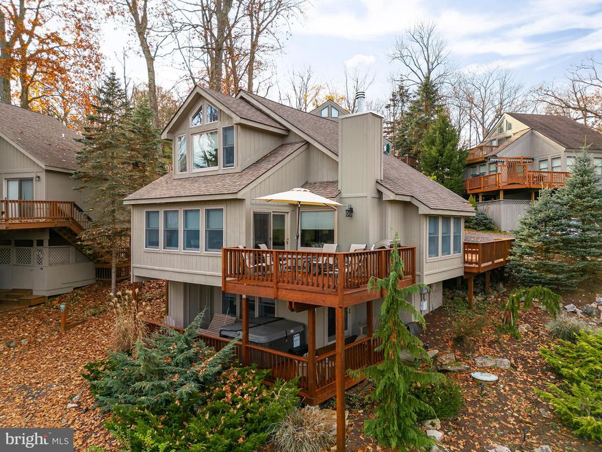 One of a kind 4BR, 3.5BA lake view home at Timberloft with dock slip. Remodeled top to bottom, this high-end detached condo features multiple fireplaces (gas), hardwood floors, custom bathrooms with tiled walk-in showers, heated floors, quartz countertops, multiple ovens, stainless appliances, eat-in kitchen and more! Professionally decorated and appointed, conveys TURN KEY with designer furniture, decor and electronics. Freshly stained decks in October 23 and recently added gutters & downspouts. Community recently installed new concrete walkways to the dock area. Owner attention to detail and very well maintained. Established vacation rental, Lasting Impressions. Rental income is $42k in 2023; $38k in 2022 - rare property that earned more in 2023 vs 2022.