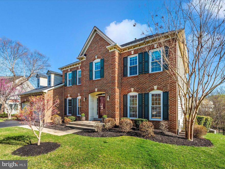 This stately NV home is ideally located at the end of a cul-de-sac on a premium lot backing to trees. The beautifully landscaped backyard features a terraced design with a stone patio, retaining wall, and a spacious, low-maintenance deck. A large side yard with a playset adds to the outdoor appeal. Enjoy breathtaking views on this expansive 0.43-acre lot—one of the largest in the community! Conveniently within walking distance to shopping, restaurants, and the library.

Inside, the main level boasts a bright and airy kitchen that opens to the deck and patio, a dramatic two-story family room with a gas fireplace, formal living and dining rooms, plus a generous bonus room/office and a powder room. Upstairs, the charming owner’s suite offers a full bath and a huge walk-in closet, accompanied by three additional spacious bedrooms and two more bathrooms.

The fully finished walkout basement is perfect for entertaining, featuring a large rec room with a wet bar and fireplace, a fifth bedroom with a full bath, and a bonus/media room. Roof replaced in 2021.