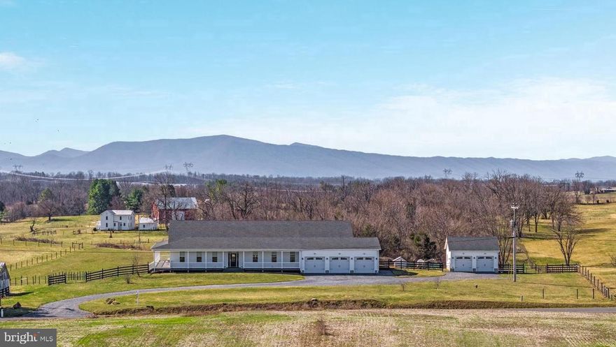 Nestled in the scenic countryside of Winchester, this impressive custom built home offers space, privacy, and beautiful Shenandoah Valley surroundings. Located in Frederick County, the property combines peaceful rural living with convenient access to shopping, dining, and commuter routes.
Custom built in 2020, this spacious residence offers approximately 4,800+ square feet of living space on the main level with 4 bedrooms and 4 bathrooms, office/exercise room, featuring generous living areas and a thoughtfully designed layout ideal for both everyday living, cooking, gatherings, and entertaining.
The main level having wide hallways, spacious rooms, low ovens, comfort height toilets and front loading laundry makes this home handicap accessible. This one of a kind custom home built with low maintenance in mind.
Situated on 10.41 unrestricted acres, the property provides plenty of room to enjoy the outdoors while maintaining privacy and flexibility for a variety of uses. A full unfinished basement with a bathroom rough-in, offers excellent potential for future expansion, allowing space for additional living areas, a recreation room, a home gym, or a workshop.
Car enthusiasts and hobbyists will appreciate the 3-car attached garage along with a separate 2-car detached garage, providing abundant parking and storage. The property is also well suited for horse lovers, featuring fenced pasture and a run-in shed, making it ready for horses or other livestock.
The property is set up for a homestead with blue berry  and black berry bushes, fruit trees, 2 vegetable gardens, fenced pasture and backyard, and composting area.
Enjoy the tranquility of country living while still being just a short drive from historic downtown Winchester, local shopping, dining, and outdoor recreation. With unrestricted acreage, equestrian potential, and modern construction, this property offers a rare opportunity for privacy, space, and convenience in the Shenandoah Valley. All sizes are approximate.