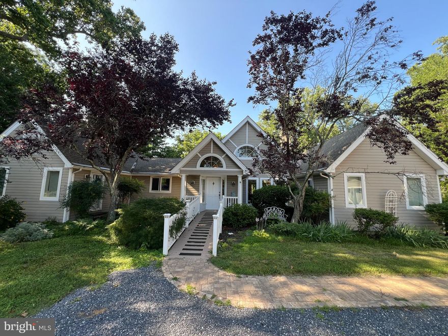 Privately situated along the Oxford Road corridor, Heron Rest is a custom Pam Gardner–designed waterfront home that beautifully blends Eastern Shore charm with modern functionality. Built in 1995 and set on approximately two acres overlooking Peachblossom Creek, this property embodies the essence of relaxed waterfront living.
The home features cathedral ceilings and hardwood floors throughout the great room and dining area, anchored by a striking wood-burning marble fireplace. The spacious kitchen is equipped with double wall ovens, a gas cooktop, generous cabinetry, and a walk-in pantry with wine storage. A butler’s pantry, laundry room, and mudroom/side entry add convenience and thoughtful flow to the layout.
The primary suite includes an adjoining library with custom built-ins and a vaulted ceiling, while two additional bedrooms share a hall bath. A large screened porch features tile floors, rattan shades, and a gas fireplace, an inviting retreat with tranquil water views.
A detached three-car garage includes second floor storage for an office or studio. The waterside deck and gently sloping lawn lead to a private pier on Peachblossom Creek.
Located just minutes from downtown Easton and  Oxford, Heron Rest offers a rare combination of privacy, craftsmanship, and timeless Eastern Shore beauty.