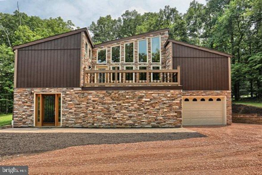 ONE OF A KIND,TRULY CONTEMPORARY HOME IN THE COUNTRY,WITH PRIVACY,LOVELY VIEWS AND CLOSE PROXIMITY TO MAJOR HIGHWAYS.  FEATURING LR WITH CUSTOM BOLIVIAN ROSEWOOD FLR,LARGE PELLA  WINDOWS OVERLOOKING TREX DECK.UPDATED KITCHEN W/STACK-STONE FIREPLACE,GRANITE COUNTERS,LOVELY MAPLE CABINETRY.  NEW HEAT PUMP W/PROPANE BACKUP, NEW PELLA DOORS & WINDOWS,  2 SPIRAL STAIRCASES,LOFT AREA WITH SAUNA.MASTER BR HAS SEMI-  VAULTED CEILING,WI CLOSET,SLIDING DRS.TO PATIO.FINISHED LOWER  LEVEL HAS GAME/FAMILY RM.