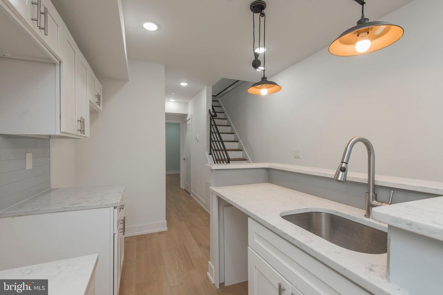 Awesome space  on a great block less than 1/2 block from Girard Ave commercial corridor. Brand new construction.  Enter to the open concept main living area, with 20ft high ceilings, recessed lighting, high end kitchen with quartz countertops, stainless steel appliances, awesome pendant lighting over the raised breakfast bar, gorgeous hardwood looking ceramic tile. There is a loft space overlooking the living room, which is an awesome space as an office or second sitting room.  This room can be enclosed with framing, drywall, paint, and two 30" interior windows if desired.  2 other good sized bedrooms and super sleek and modern bathrooms .  Full laundry in the unit, and a private rear yard round out the space.  This is truly unique.  Schedule your tour today.