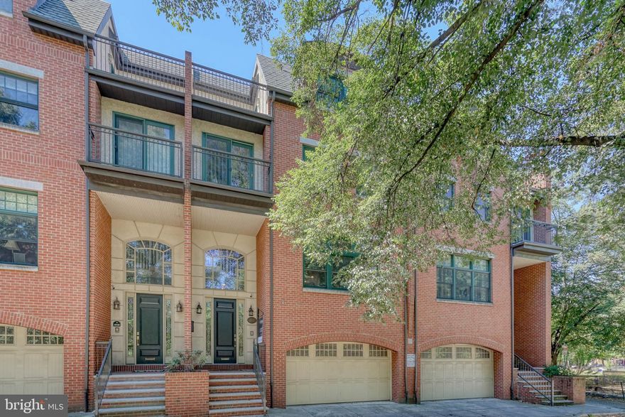 Fitler Square's picturesque Schuylkill River Park acts as the sprawling foreground for 2518 Delancey Pl. This towering 3,800 SqFt home offers 4 bedrooms, 3 bathrooms, a 2-car garage, and multiple outdoor spaces, all in the prestigious Greenfield school catchment. The front of the home features a classic brick facade and a grand, elevated entry adorned by an arched transom window. Inside, you're welcomed by a 2-story foyer. Durable LVP floors extend throughout the first level, where there's access to the oversized 2-car garage, a coat closet, a laundry closet, a full bathroom, and a huge bonus room, perfect for a den, playroom, gym, or home theater. Out back, the large private patio has plenty of space to create a relaxing garden oasis. Up on the home's main level, you'll find a bright, airy, and open layout with soaring ceilings trimmed by crown molding and beautiful hardwood floors. Off the staircase, there's a large dining area and sliding doors that lead to a balcony, ideal for summer entertaining. The stunning kitchen is fitted with white cabinetry, high-end GE stainless steel appliances, granite counters, and a center island with seating. At the front, the living room is anchored by a wood mantle framing the gas fireplace and filled with natural light from an expansive picture window overlooking the park's trees. On the third level of the home, there's a large bedroom with a custom closet at the rear. The primary suite sits at the front. It consists of a massive bedroom with a sitting area and balcony, double walk-in closets, and a luxurious full bathroom equipped with dual vanities, a soaking tub, glass enclosed shower, and a water closet. The fourth level completes the home with an open bonus space, a full bathroom, two spacious carpeted bedrooms with walk-in closets, and two more balconies. Amenities include speakers wired throughout, central a/c, electric and gas water heaters, and gas heat. 2518 Delancey Pl's highly sought-after Fitler Square location earns a Walk Score of 94! Lively yet peaceful Schuylkill River Park and the extensive Schuylkill River Trail are right out front. Neighboring Rittenhouse Square is overflowing with shops, restaurants, and theaters to explore, plus nearby South St is lined with markets and storefronts. There's also easy access to public transit, I-76, and The University of Penn. Schedule your in-person or virtual tour today!