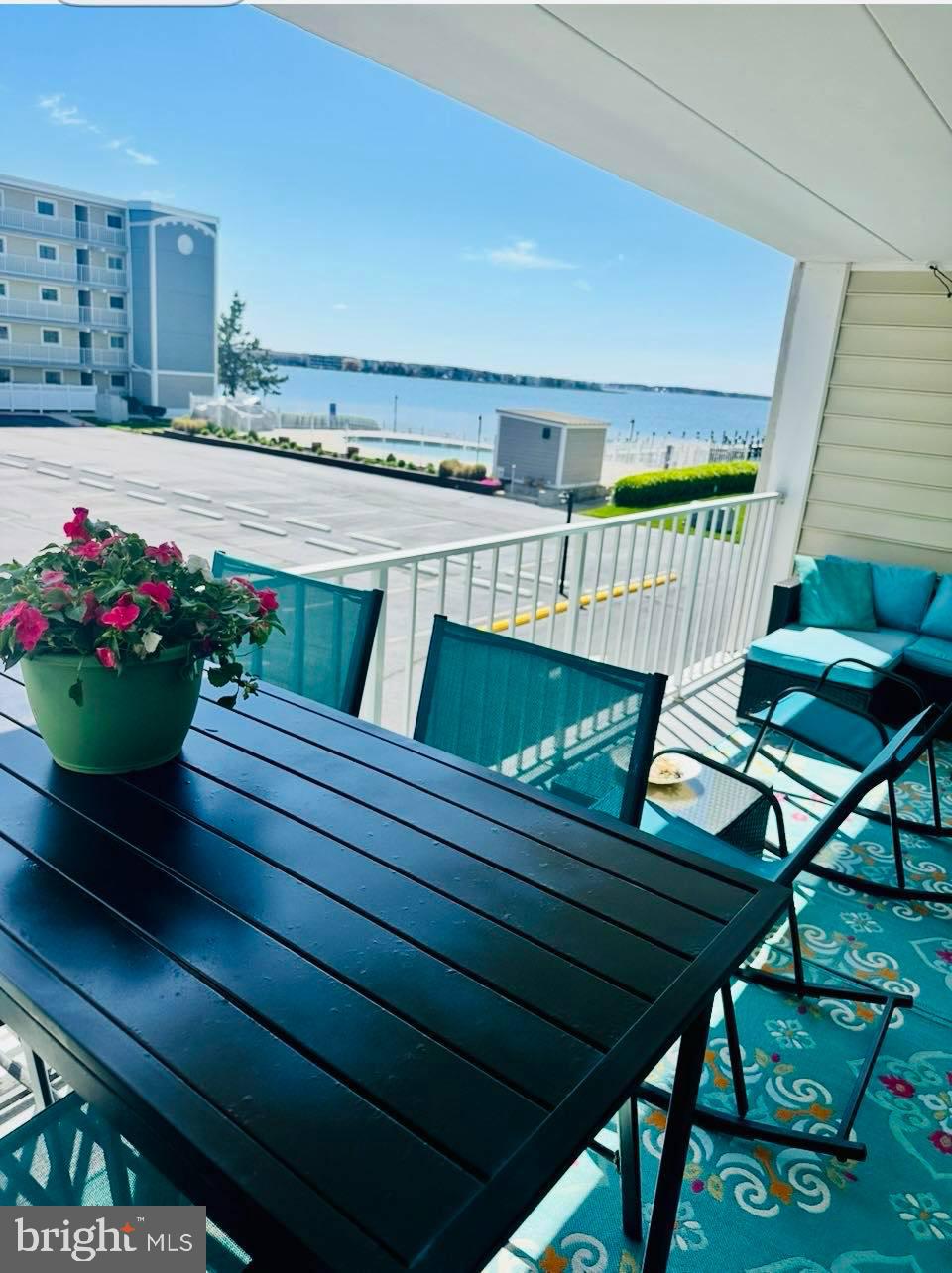 A true TURN KEY, fully furnished unit with excellent rental income of $45k+/yr at Thunder Island, set and ready to kick off summer! 2nd Floor unit - can use stairs or elevator; 2 BR/2 BA, plus a wide balcony with spacious storage closet. Enjoy stunning views of the Bay, piers, boat slips and the large In-ground pool. Entering the unit you will feel immediate relaxation with an open concept floorplan, coastal decor, and an abundance of natural sunlight. The kitchen was updated in 2019 featuring soft-close cabinets, granite countertops, pull-out drawers, and pull-out trash, with new stainless steel appliances added in 2023. Additional upgrades include a new washer/dryer (2019), and updated bathrooms. LVP flooring flows throughout the main living area, with cozy carpet in the bedrooms. Easy parking with 2 unassigned parking spots. PLUS - the building also permits on-site parking for boat trailers and includes showers to rinse off sand from the beach, a picnic table area, & on-site dumpsters! Thunder Island has a great reputation with clean grounds, nice landscaping, as well as the convenience of being close to OC's Convention Center & close to the Beach! Don't miss out on this opportunity to lock in your beach retreat or investment property with proven results, just in time for summer!
