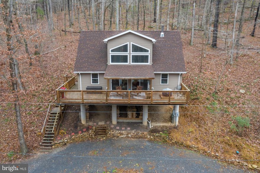 Stunning River Front Chalet, setting high and dry along the Cacapon River, newer constructions allows for open floor plan with 3 bedrooms 2.5 baths and laundry on the main level. Wood floors, wood stove, high ceilings and lots of windows for viewing nature. Central air and heat, heated floors in master. Comes fully furnished and ready to enjoy. Large deck and covered porch for entertaining.  Level lot  to the river for easy access and all your outdoor activities, just imagine setting around the campfire and listing to the crackling fire. May also be purchased with extra lot. Make your appointment today!