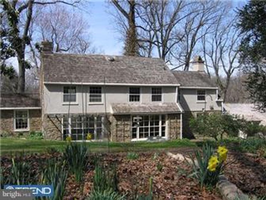 Stunning setting, new roofing, new chimney liner, fresh paint, attentive maintenance, gorgeous gardens, over three private acres in Lower Merion!! Turn in between urns atop stone pillars and wind down a private lane circling a huge tree to this Walter Durham designed home with guest cottage.  The stone and stucco house has four fireplaces, a panelled library, a brick-floored sunroom, today's kitchen/family room (reconfigured from former maids' rooms), and a first floor master bedroom, in-law suite, or home office.  There are garages for three cars followed by a garden or pony shed, and a two-story guest cottage with one bedroom and bath.  Truly a charming property, and a secluded setting that is an incomparable three-plus acre natural landscape enhanced by stone steps, walls, terraces, garden paths and woods.