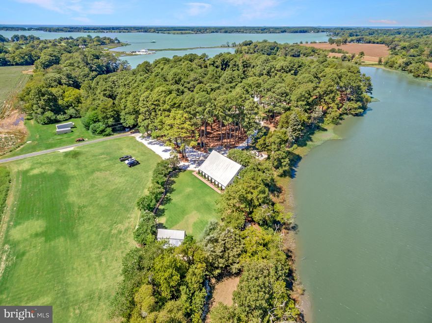 *Mimosa Farm: A Bespoke Waterfront Legacy*An offering of unparalleled distinction, Mimosa Farm represents a rare opportunity to acquire a meticulously restored and totally renovated historic estate. This 17.1-acre waterfront property, boasting over 1,500 feet of natural shoreline, seamlessly combines the charm of its 1850 heritage with the pinnacle of contemporary luxury and convenience. The estate features a grand main house, a versatile carriage house with a complete apartment, and an expansive restored barn with living quarters currently operating as a high-demand event venue, yet ripe for a multitude of bespoke uses.

*Key Features Include*
-5 Bedrooms (3 in Main House, 1 in Carriage House and 1 in Barn/Event Venue),
-5 Full Bathrooms ( 3 in Main House, 1 in Carriage House and  1 in Barn/Event Venue) and
-3 Half Baths ( 1 in Main House, 1 in Carriage House and  in 1 Barn/Event Venue)
-New three-bay garage/carriage house with a second-floor living suite.
-Historic barn built circa 1863, now a five-star rated event venue ("Mimosa Barn").
2,808 square feet of space with a capacity for 300+ guests plus bedroom with water view, 1 and 1/2 bathrooms, kitchenette, sitting area and flex spaces
-RV electric post next to the garage.
-Irrigation system.
-500-gallon propane tank.
-Private125' dock with a boat lift.
-Whole-house generator, water filter, and dehumidifier.
-Main house security system
-Large outdoor fire pit.
-Historic Preservation Tax Credit available 

Nestled within a serene enclave , this exquisite farmhouse-style residence, originally built in 1850 and masterfully renovated in 2019, offers a harmonious blend of historic charm and modern luxury. Spanning 17.16 acres, this property is a true sanctuary, featuring lush landscaping, a partly wooded area, and a tranquil Eyre Hall Creek that meanders at the edge pf the grounds, creating a picturesque backdrop for your everyday life. Step inside to discover an inviting interior that exudes warmth and sophistication.
 
The spacious layout includes three generously sized bedrooms and three and a half elegantly appointed bathrooms in the Main House. The heart of the home is the family room, seamlessly connected to the gourmet kitchen, which boasts high-end appliances including a six-burner gas stove, built-in microwave, and an extra refrigerator/freezer for all your culinary needs.
 
Rich hardwood and marble flooring flow throughout the home, complemented by luxurious finishes such as crown moldings and chair railings. The thoughtful design includes built-ins and a cozy bar area, ideal for hosting gatherings. An elevator provides easy access to all levels, ensuring convenience for everyone. The exterior of the property is equally impressive, showcasing extensive hardscaping, multiple balconies, and a screened patio that invites you to relax and soak in the stunning views of the creek and surrounding parterre gardens.
 
The property also features a Carriage House with space for three vehicles and a charming guest house. Additional outbuildings include Mimosa Barn, which is currently used as a 5 star event venue  perfect for visitors or as a private retreat. 

For those who appreciate an active lifestyle, the property offers private access to the creek, where you can enjoy boating, fishing, kayaking, or simply basking in the beauty of nature. The dock, equipped with an electric hoist, provides easy access for boating enthusiasts. 
Located in a secluded area yet conveniently close to local amenities, this home offers the perfect balance of privacy and accessibility. Experience the exclusive lifestyle that this remarkable property provides, where every detail has been thoughtfully curated to create a haven of comfort and elegance. Embrace the tranquility of nature while enjoying the luxury of modern living in this extraordinary Cape Charles residence.

Living area of 5,612 square feet = Main House + Carriage House Apartment (LL 2) + Living Area of Barn (LL3)